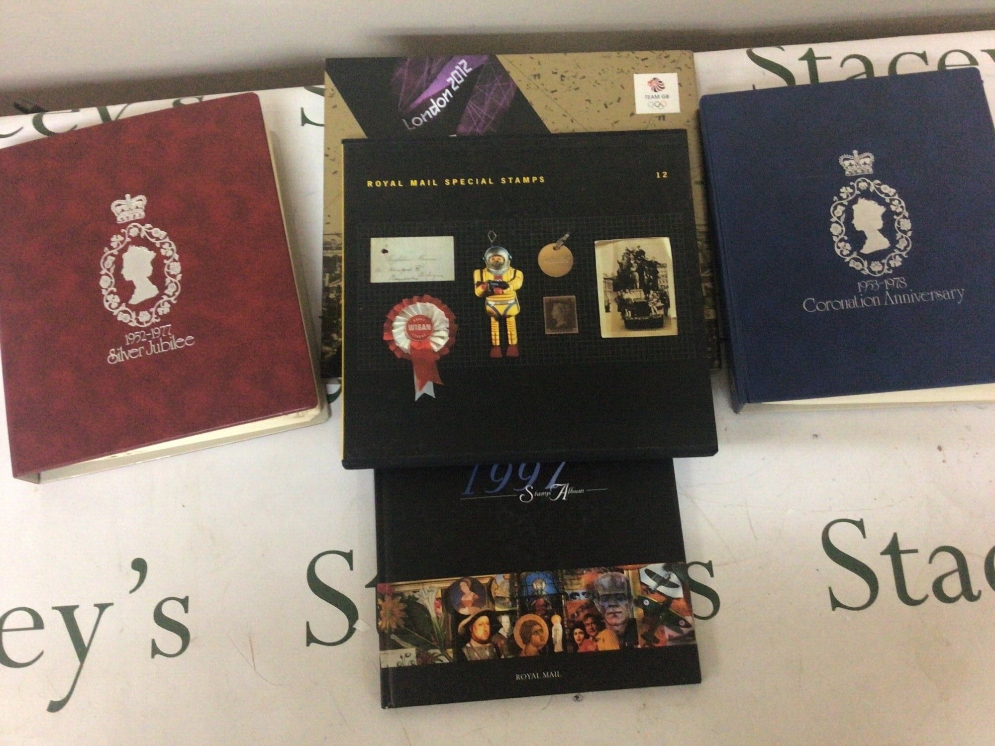 A collection of stamps comprising Royal Mail Special Stamps 12 Team GBgold medal winners stamp collection 1952-1977 silver Jubilee stamp album collection 1953-1978 Coronation stamp album and 1977 stamp album. NO RESERVE