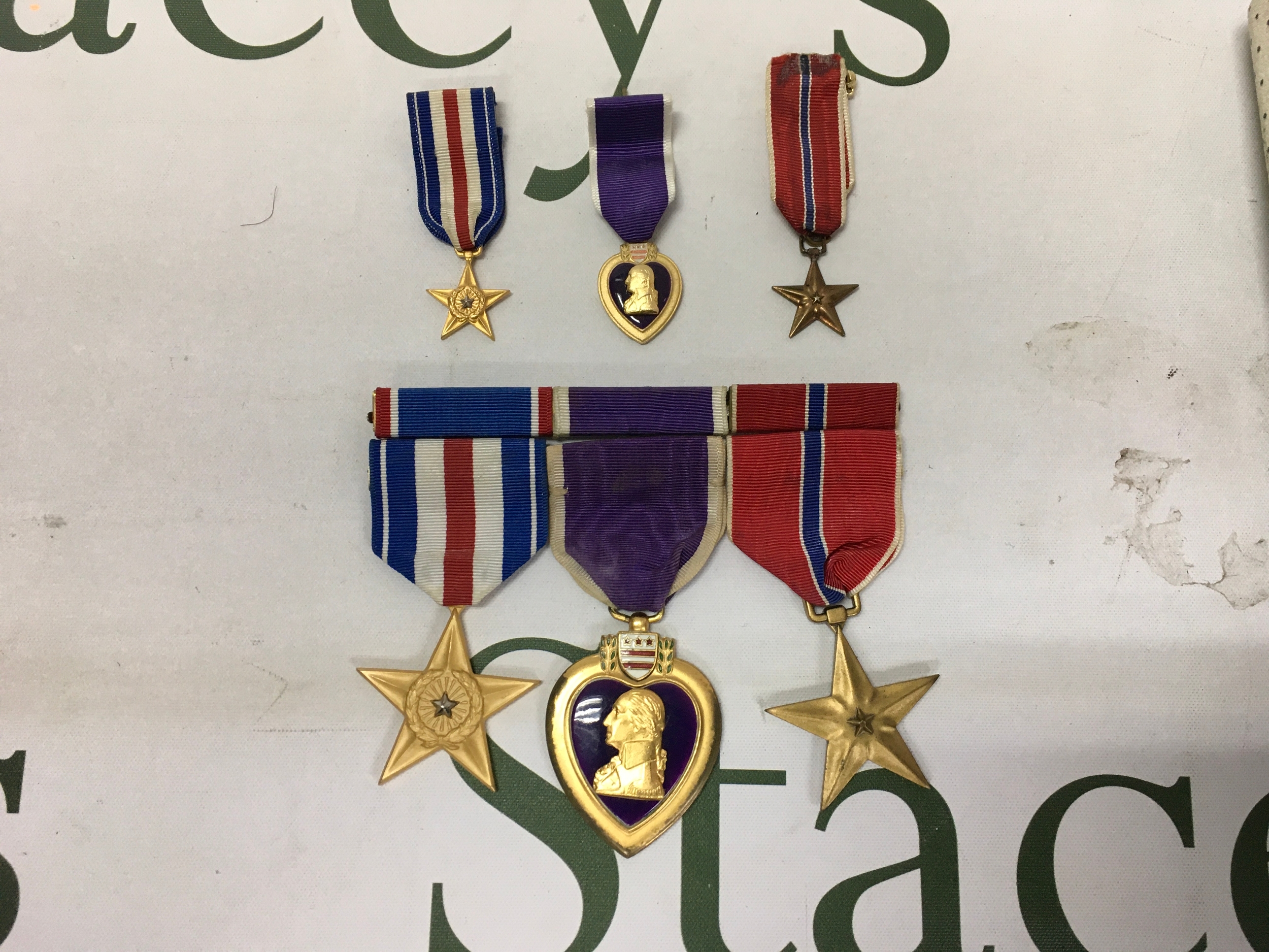 A set of United States military decorations, consisting of three full-sized medals and their corresponding miniature versions. All three of these decorations remained active and were heavily awarded to U.S. service member during the Vietnam War. No obvious damage or reconditioning.