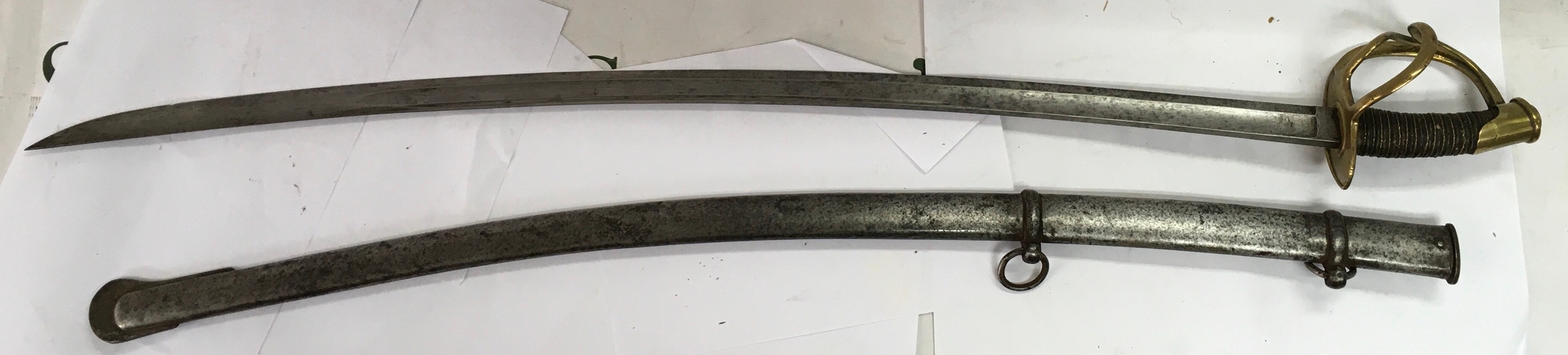 A 19th century military cavalry saber and its matching steel scabbard. 