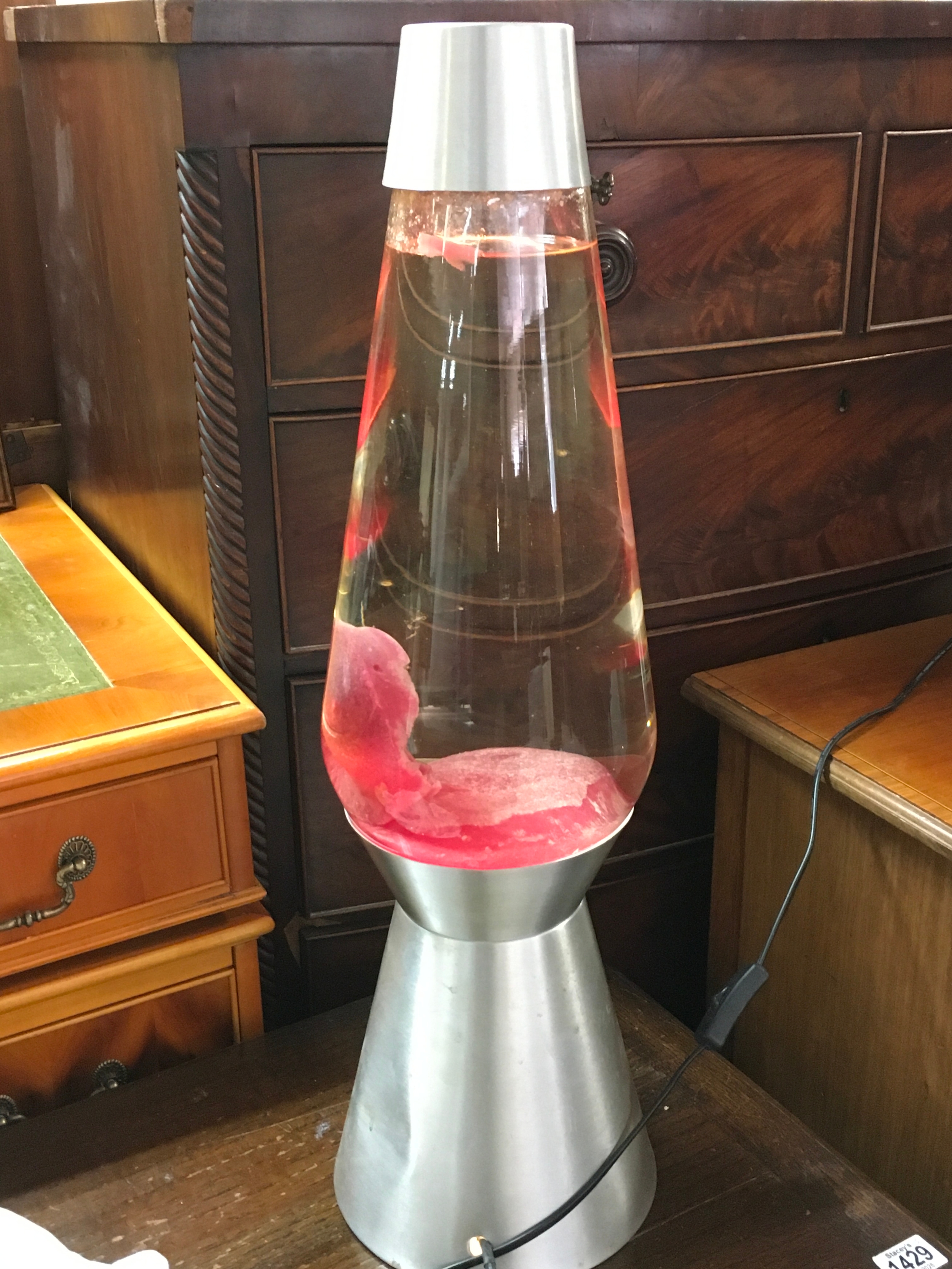 A large red lava lamp. 68cm tall. No reserve