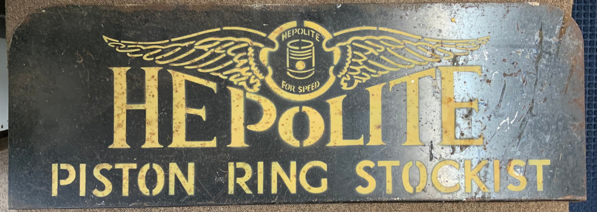 A Viintage painted advertising sign for Hepolite piston ring stockist. 36" x 12.5"