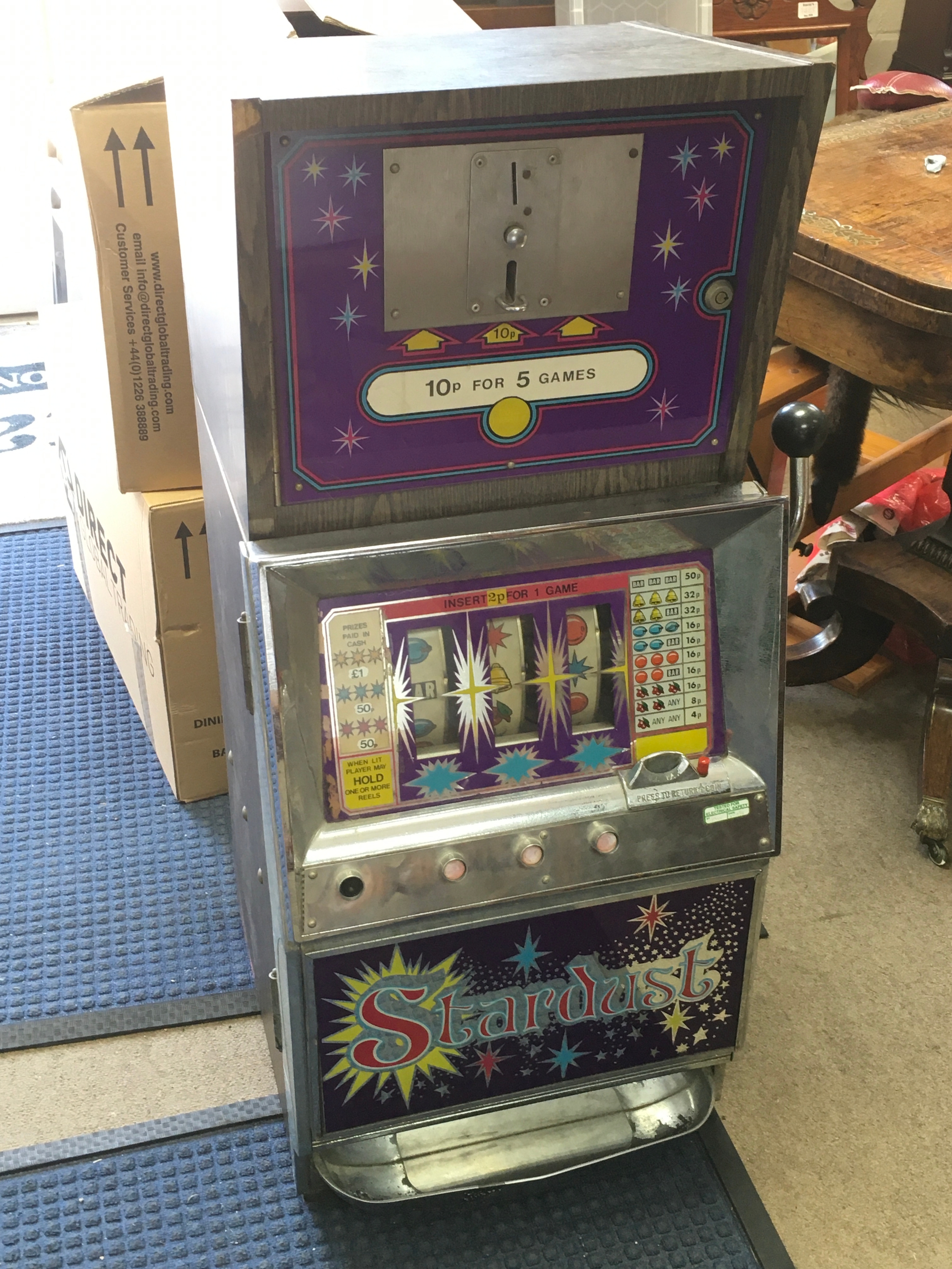 A vintage stardust three reel and hold slot machine. Seen spinning. Dimensions 98cm tall , 40cm wide