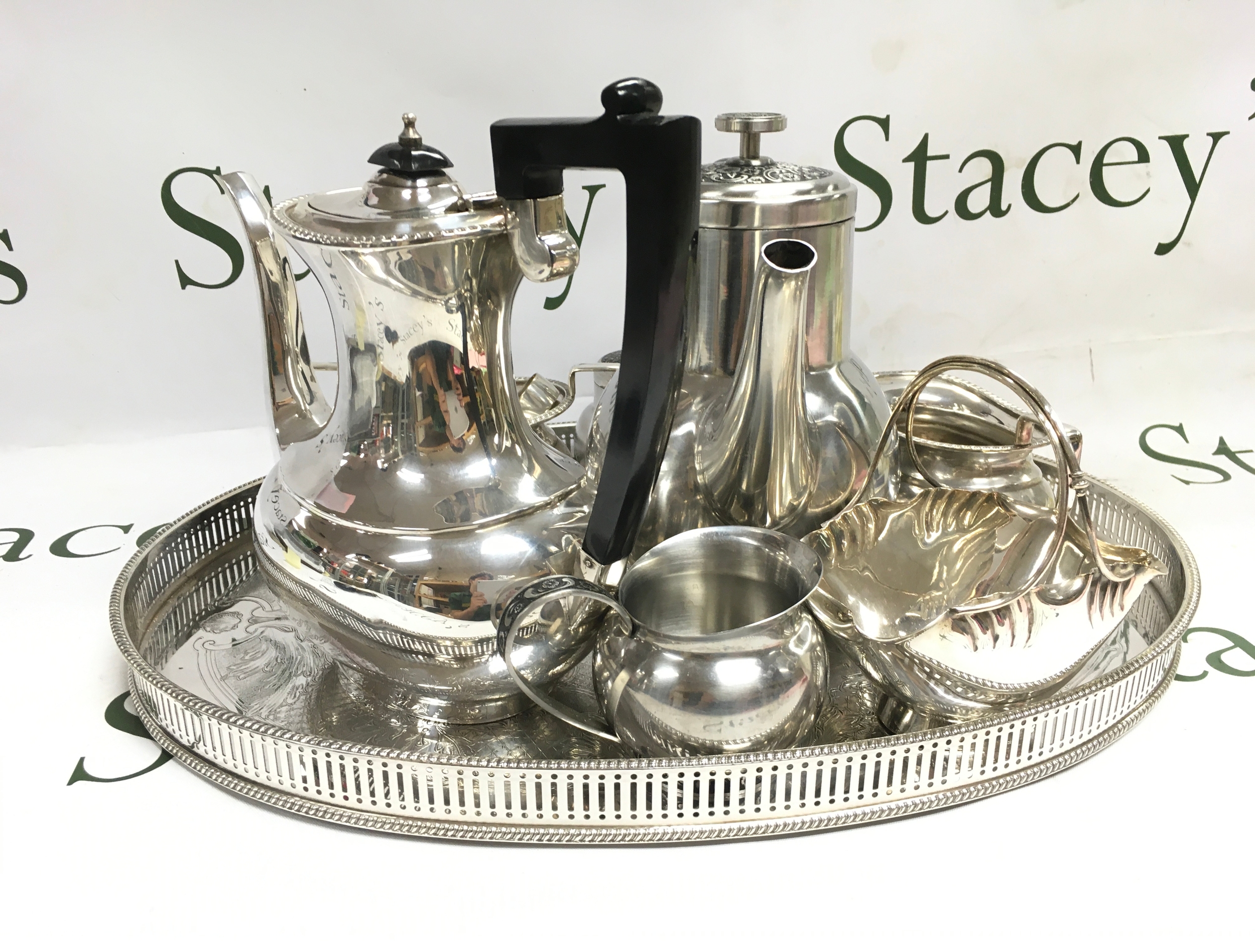 A silver plated tea set, a tray basket (46cm wide), coffee pot. Garland and Oneida