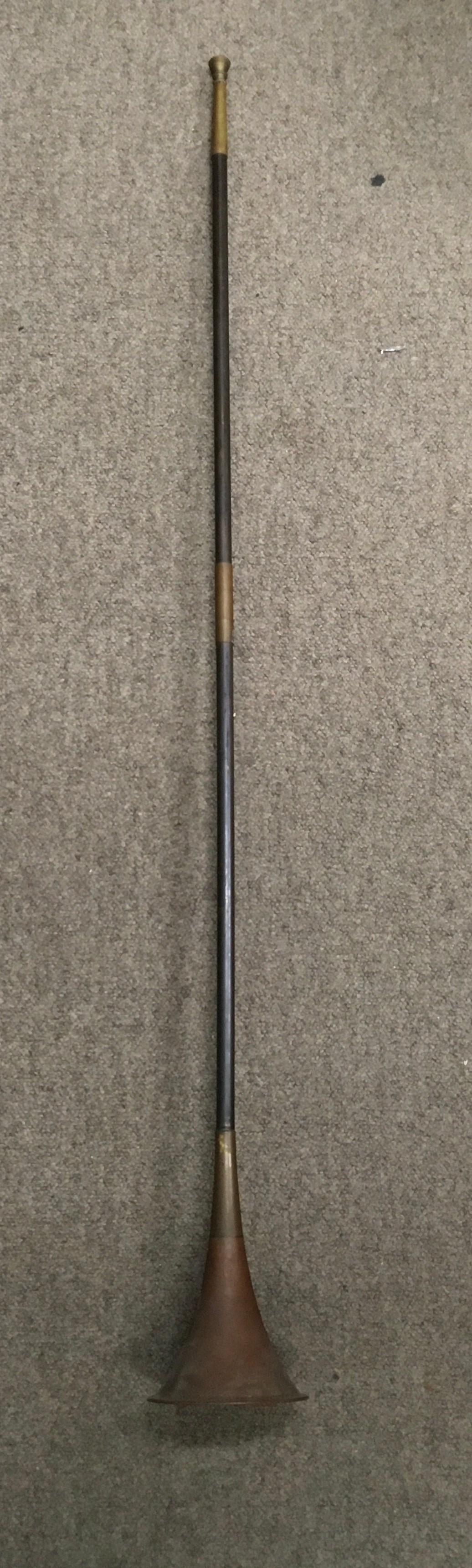 A vintage straight hunting/ coaching horn constructed with a copper body and brass mouthpiece 