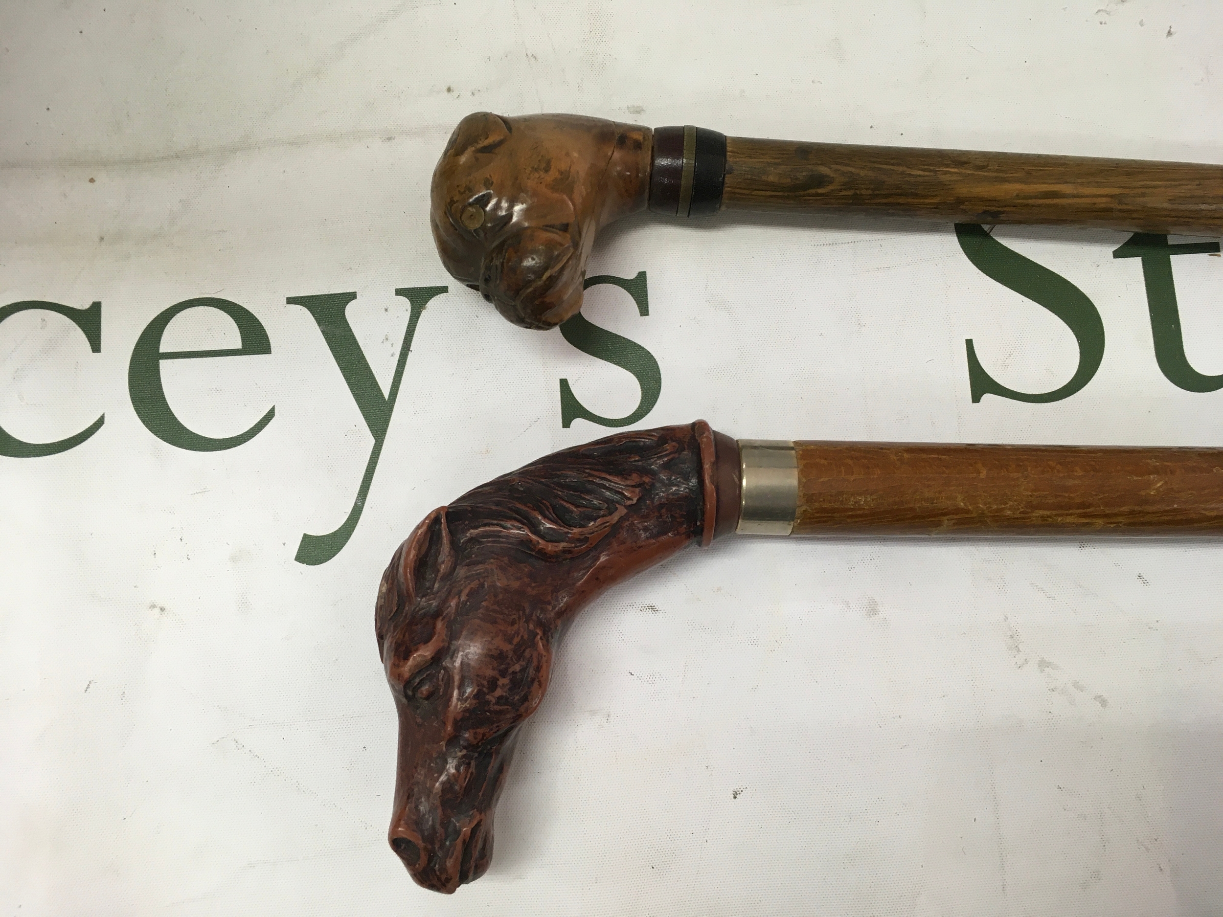 Vintage style wooden walking canes featuring decorative wooden handles. Length of top walking stick is 87cm. Length of bottom walking stick is 93cm. 