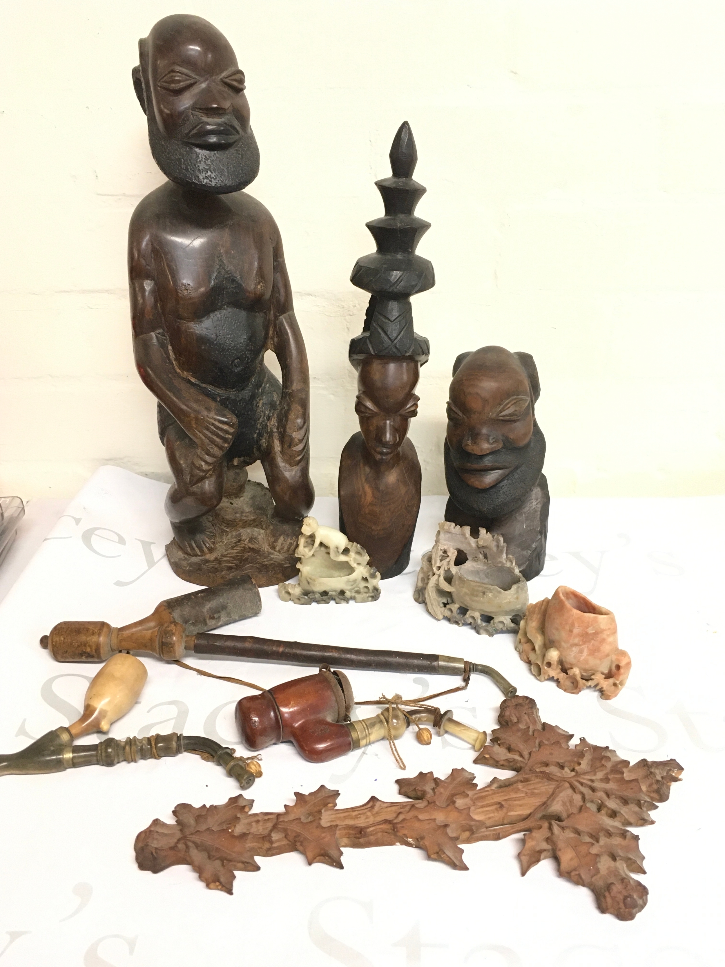 A collection of wooden African art figures (tallest 39cm), pipes, soapstone carvings. 