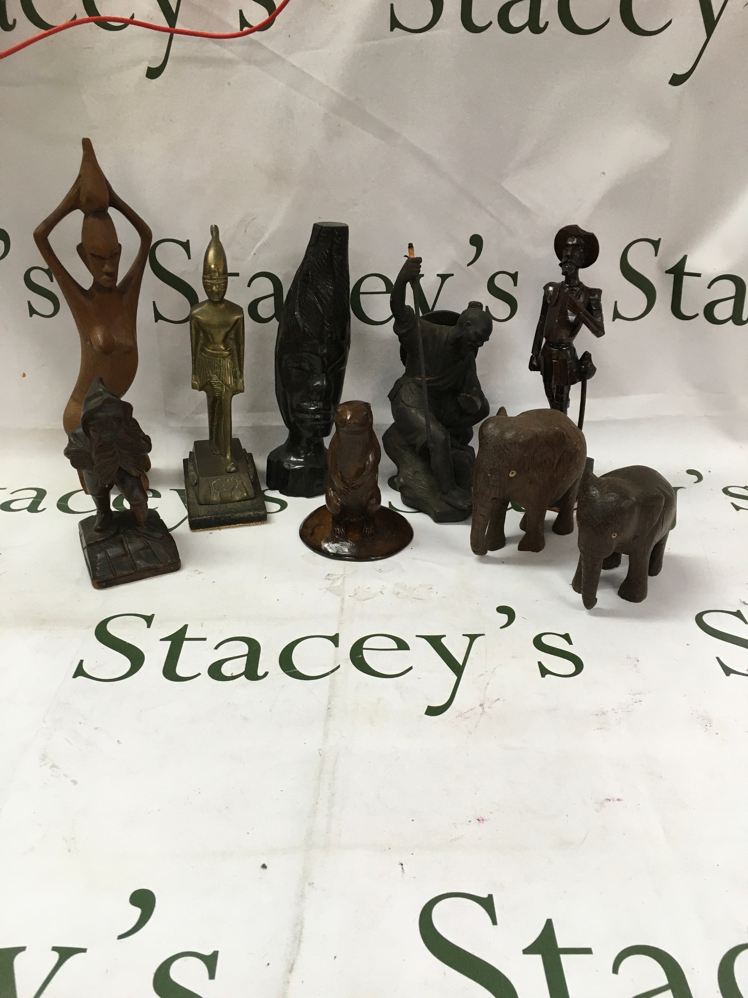 A collection of hand crafted African tribal art figures. Including a bronze figurine. 
