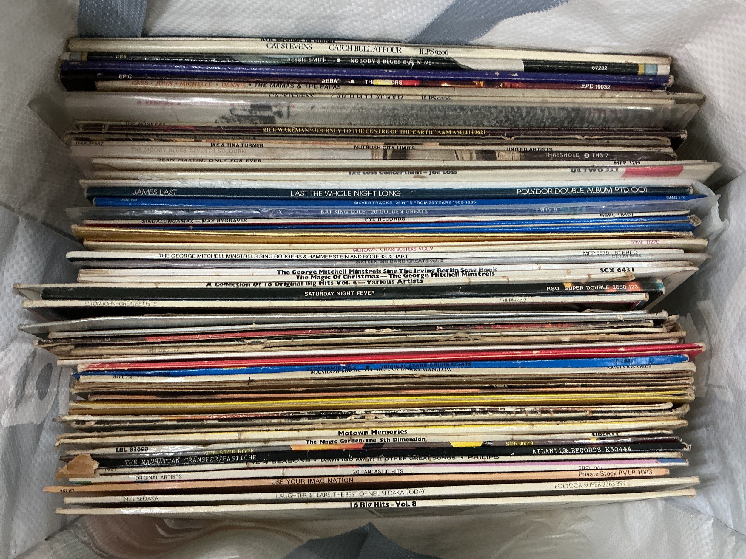 A bag of LPs by various artists including Cat Steven's, Otis Redding, ABBA and others.