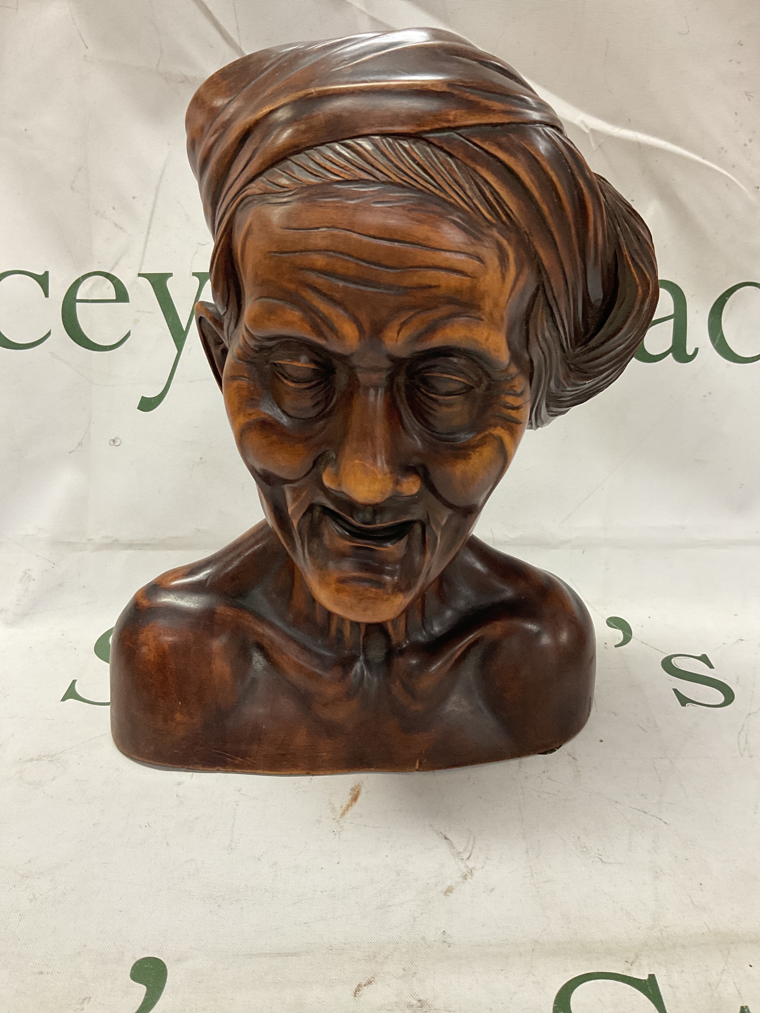 Hand carved wooden bust of an elderly Asian gentleman. H 25 cm.