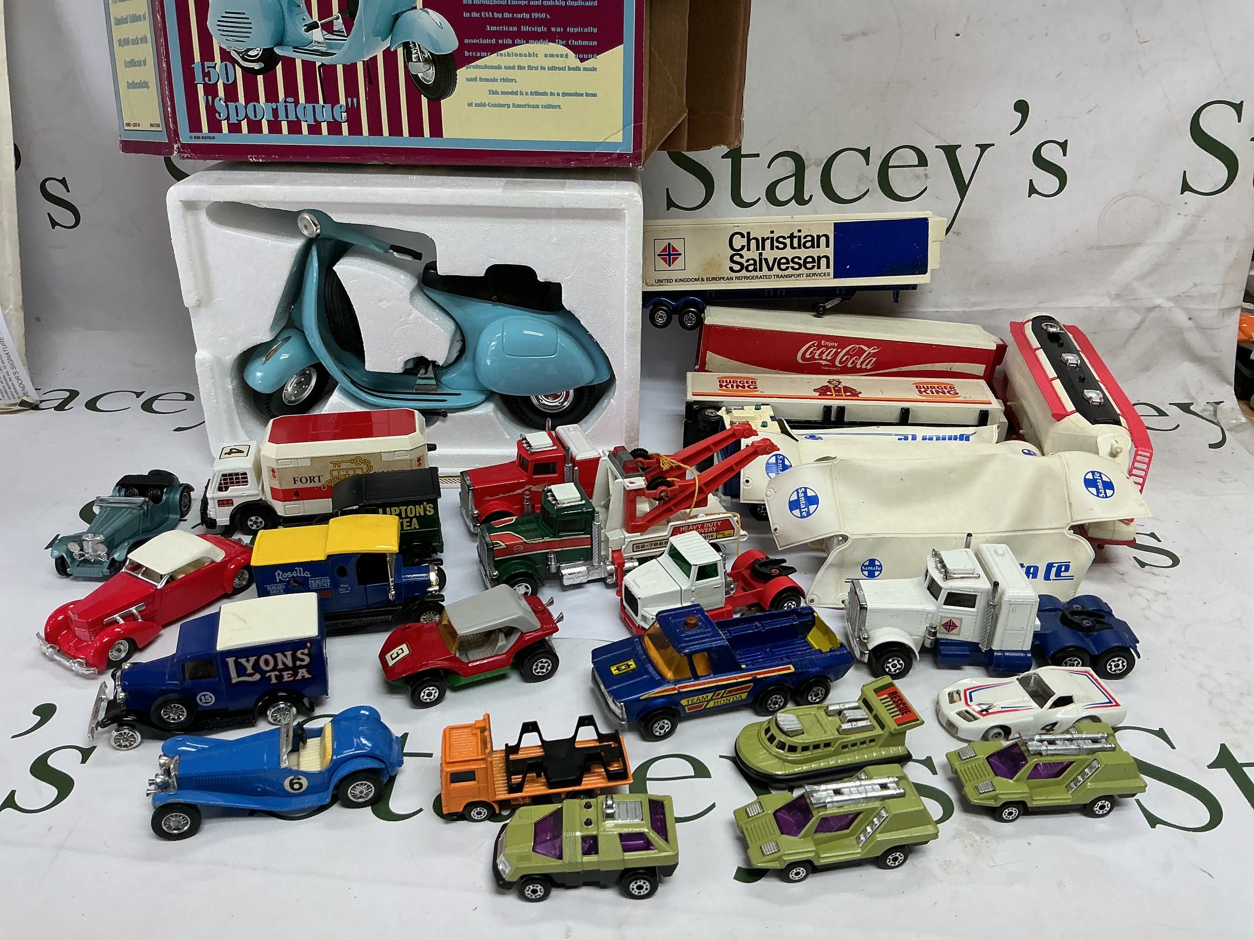 A blue box containing various die cast vehicles including Matchbox examples.