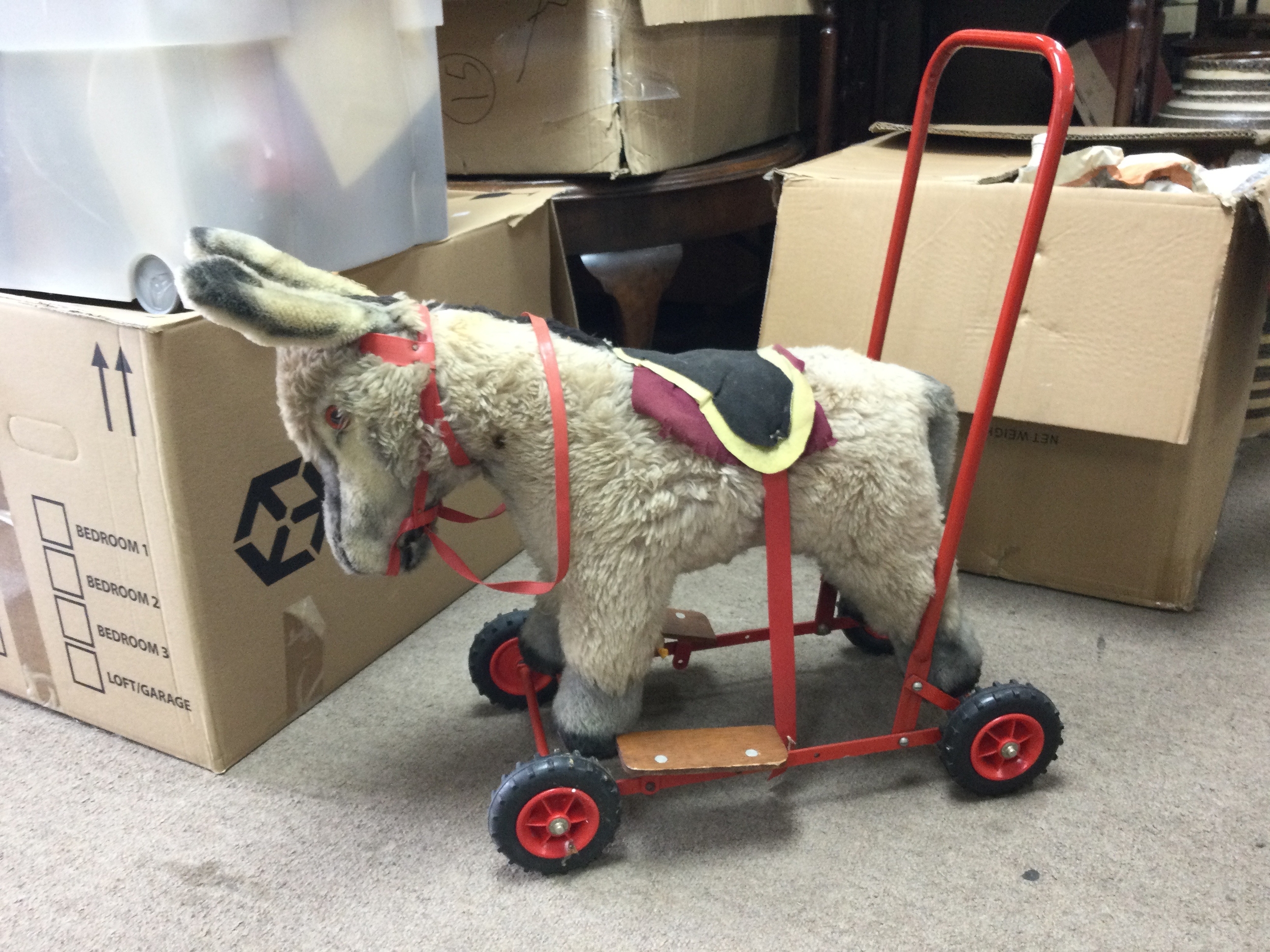 A vintage Deans push a long Donkey. 58cm tall