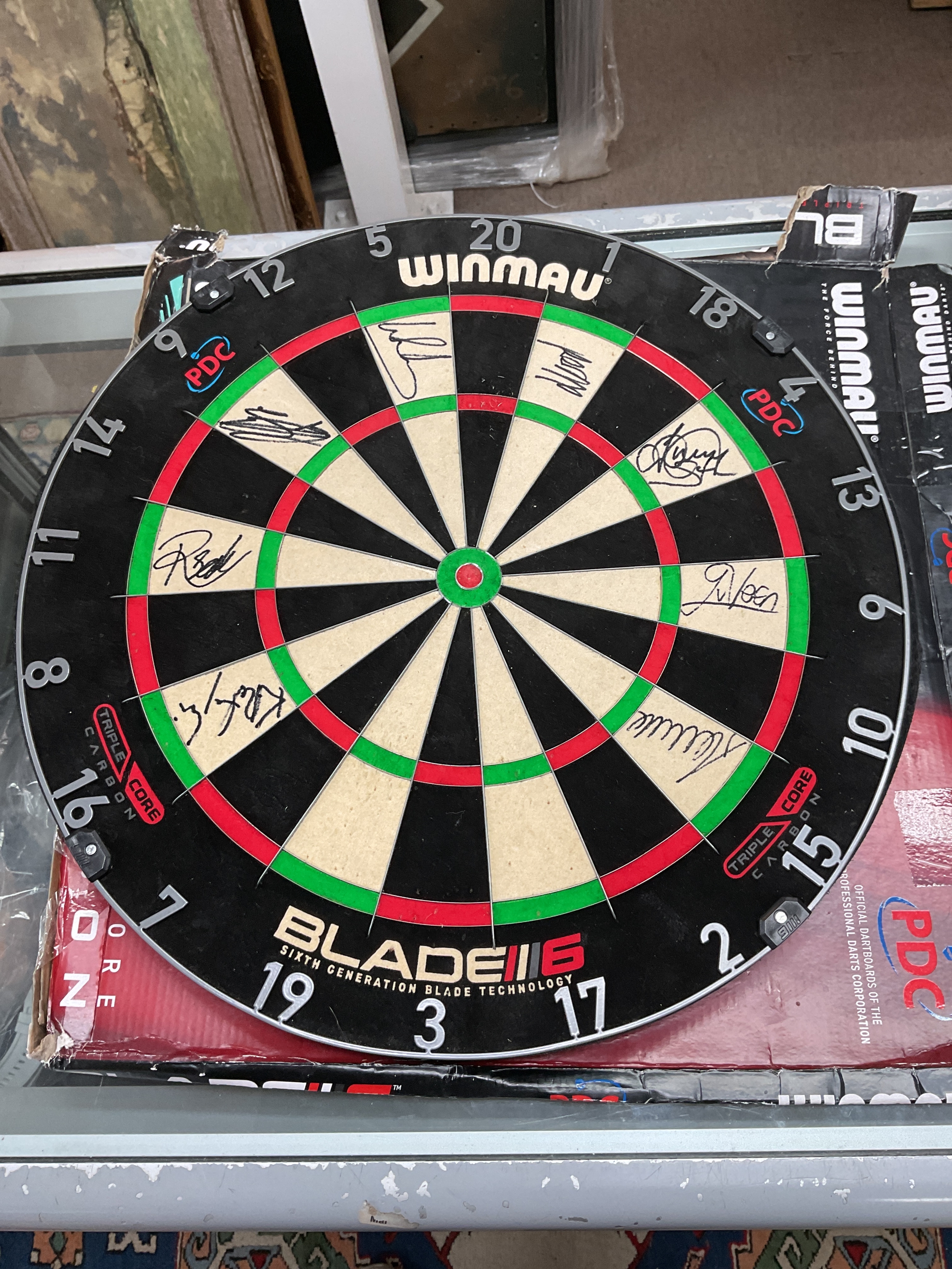 Luke Littler autographed Winmau dartboard along with other BDO players.