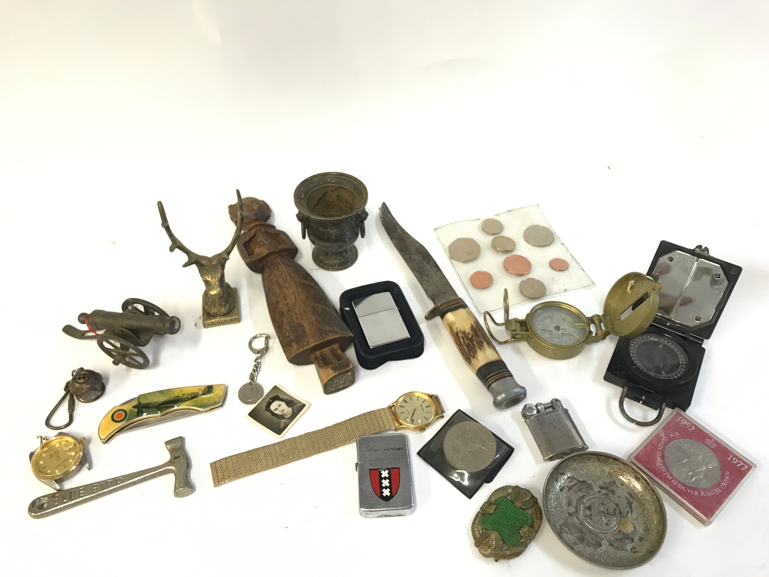 A collection of various items including a knife, lighters, compasses etc