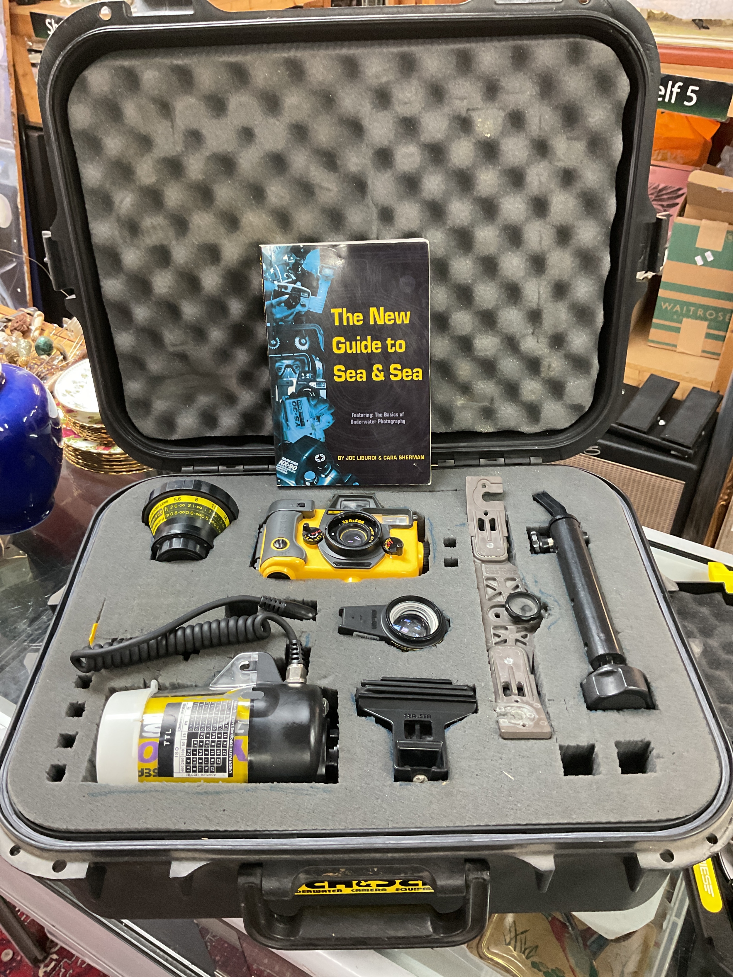 A Sea and Sea cased underwater camera along with a cased Muvi underwater video.