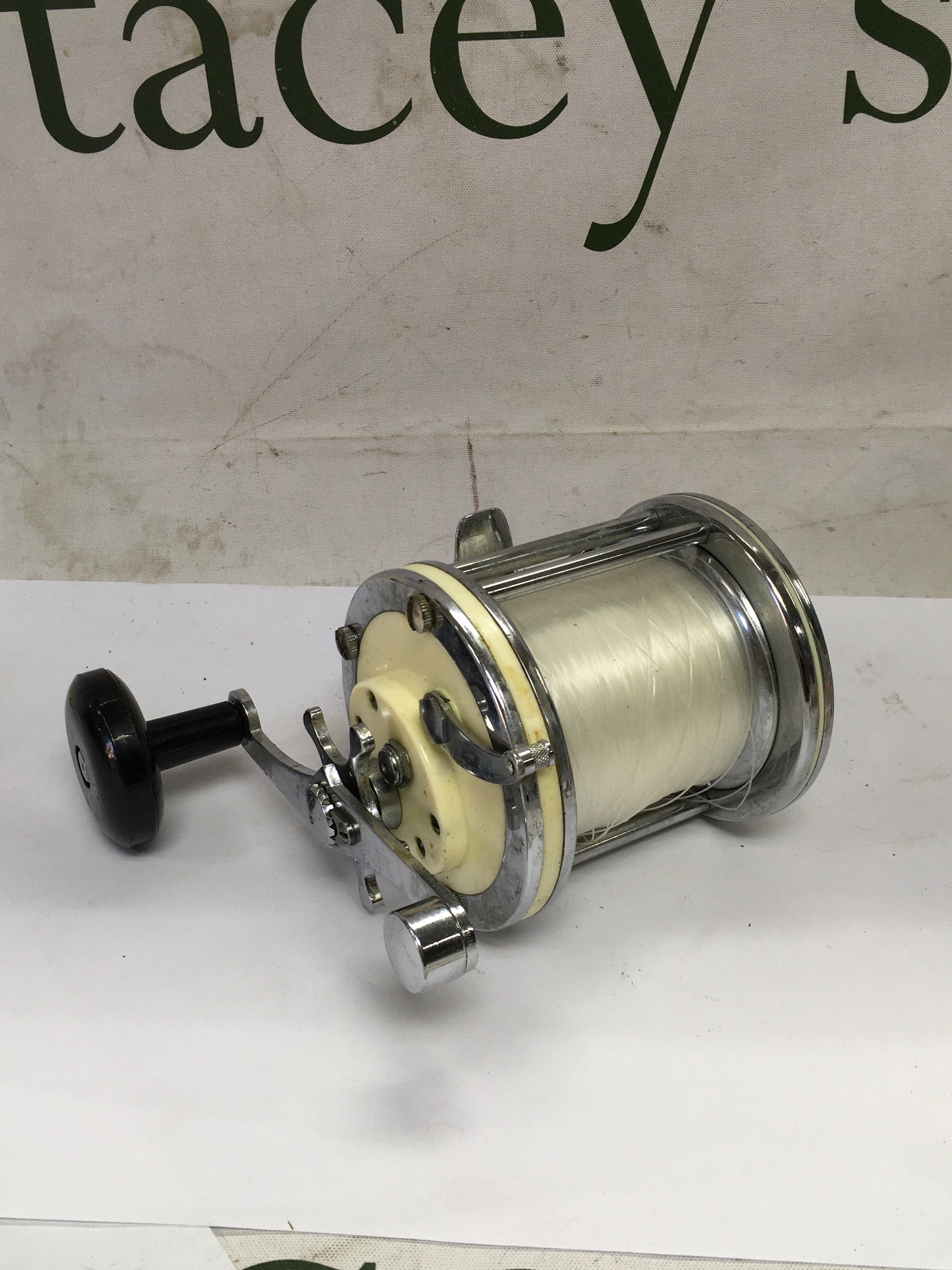 A collection of vintage and used fishing reels and line spool. 