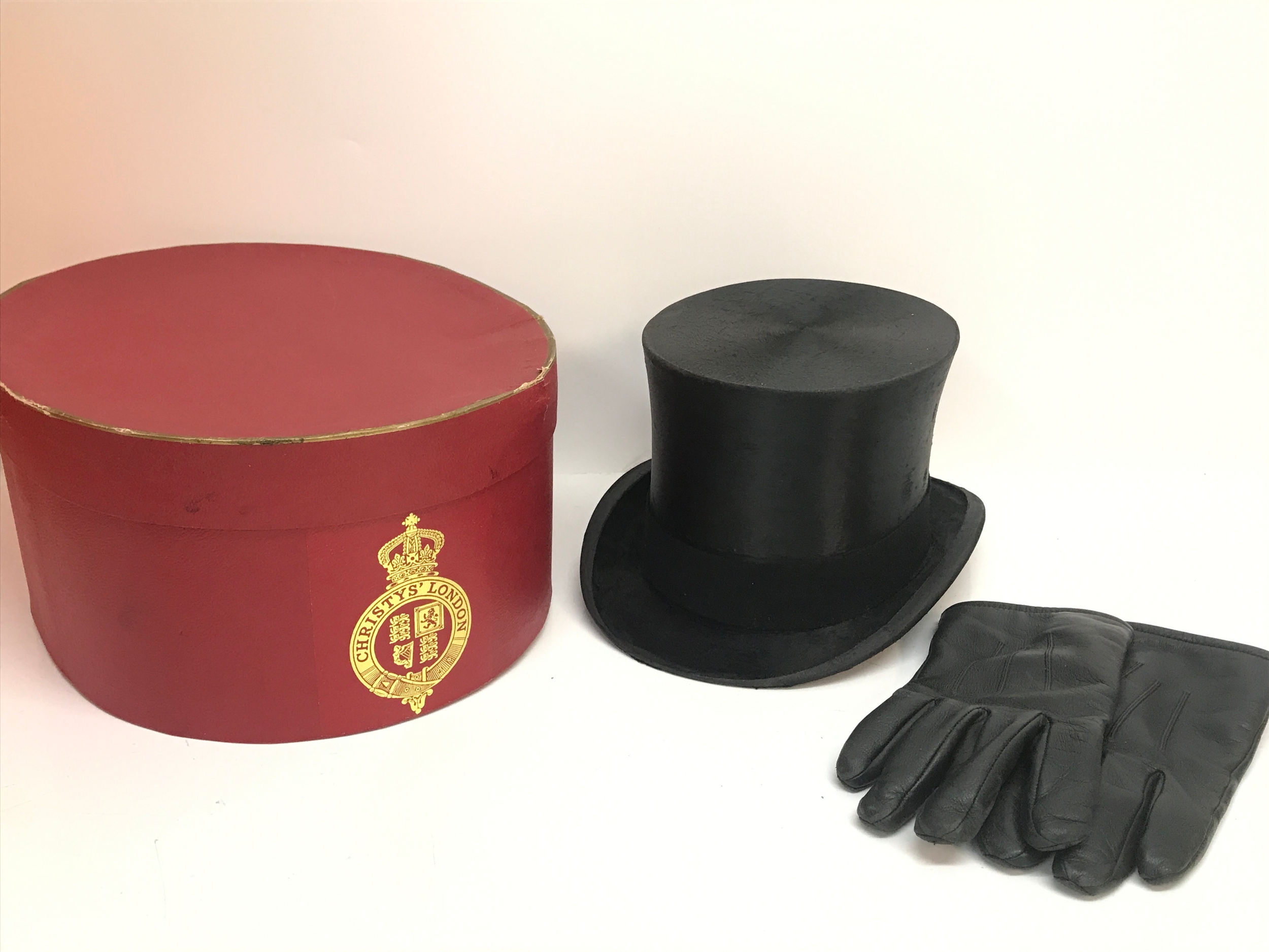 A top hat by Scott & Co with box. Also comes with leather gloves. Inside of hat 16cm wide 20cm long. Hat 17.5cm tall, 31cm long, 24cm wide.