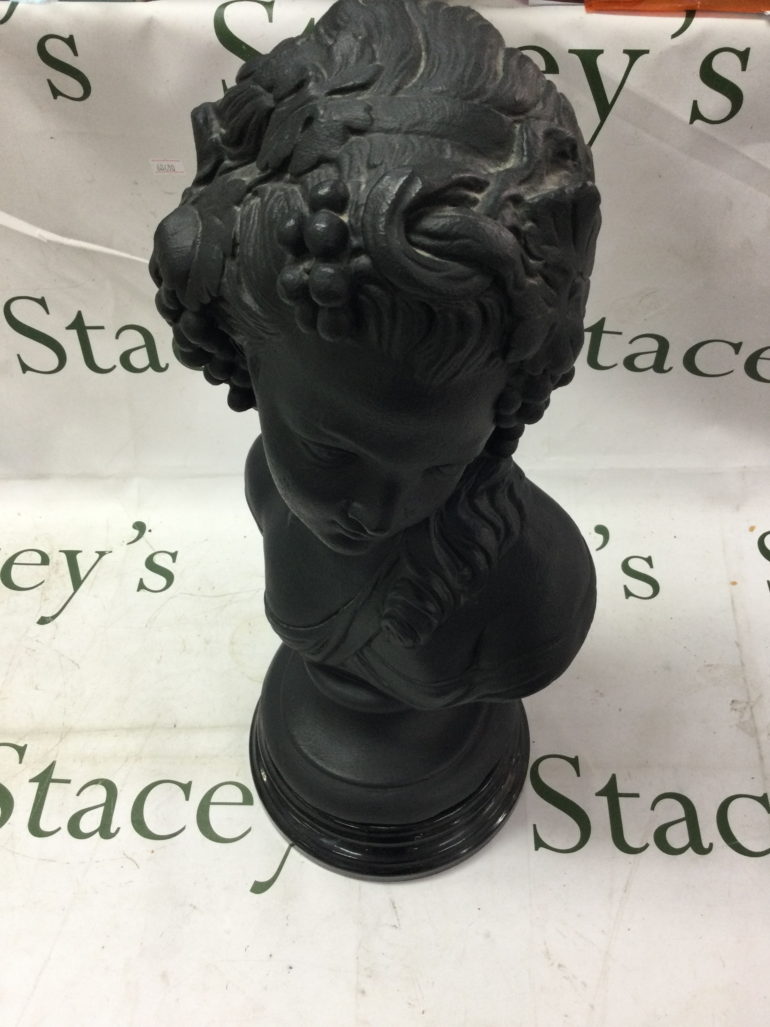 Large black painted bust of a lady with grapes in hair on socle base