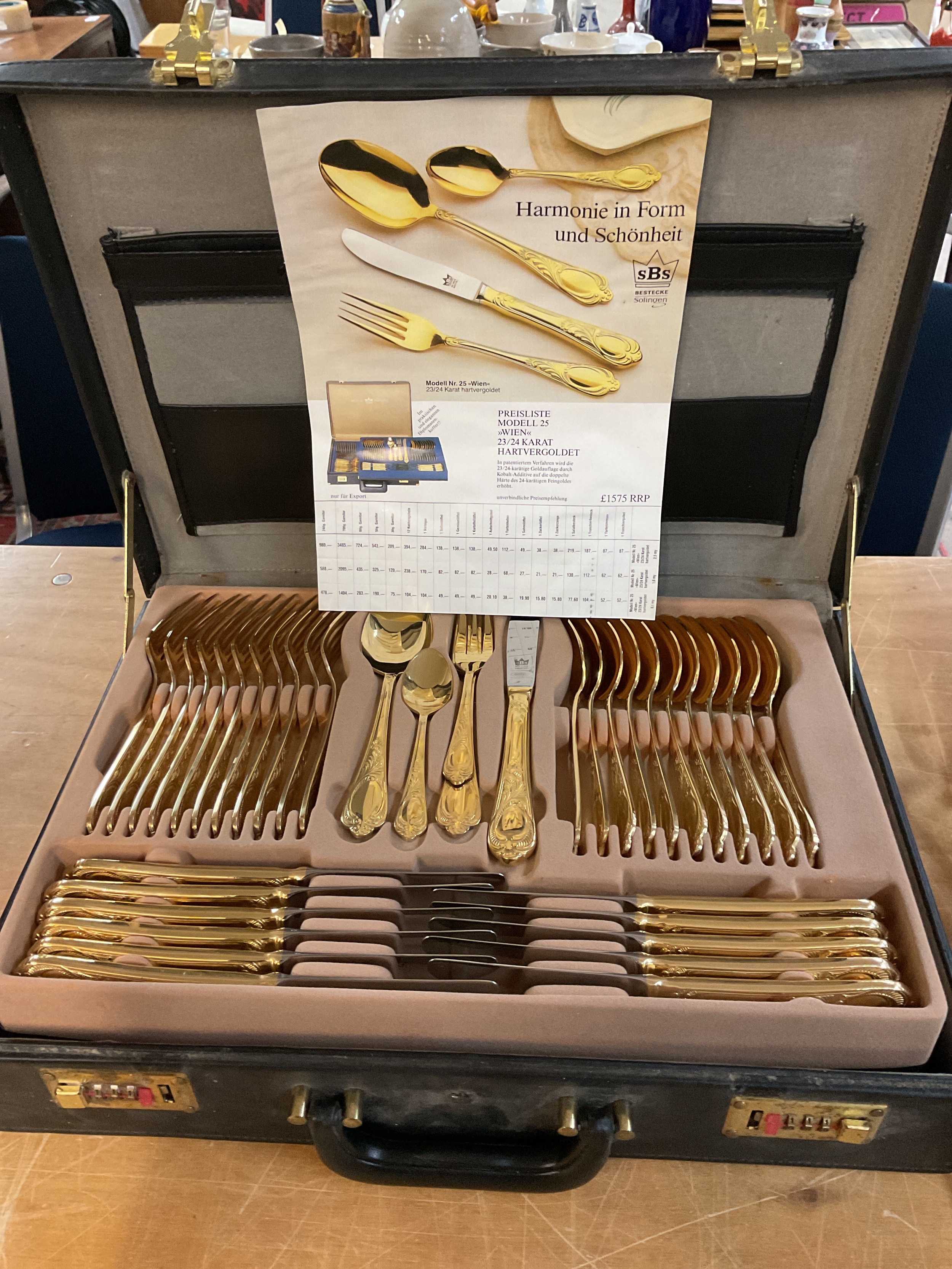 Cased set of gold plated cutlery12 place setting and servers and ladles .