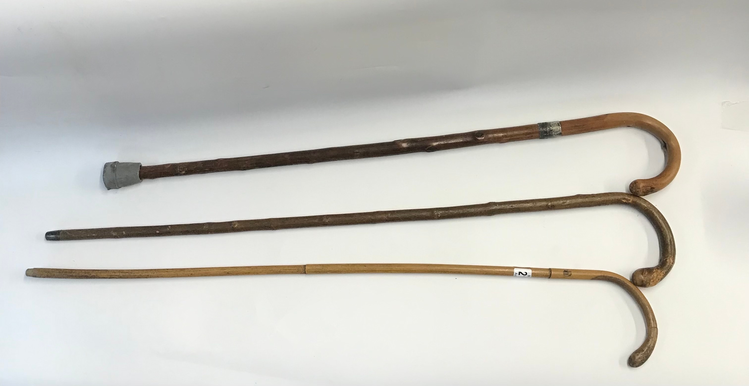A collection of three classic wooden walking canes 
