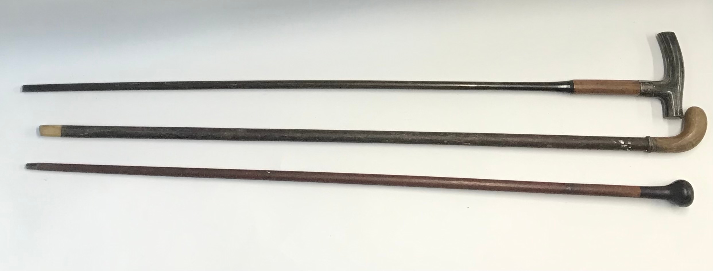 Three wooden walking canes