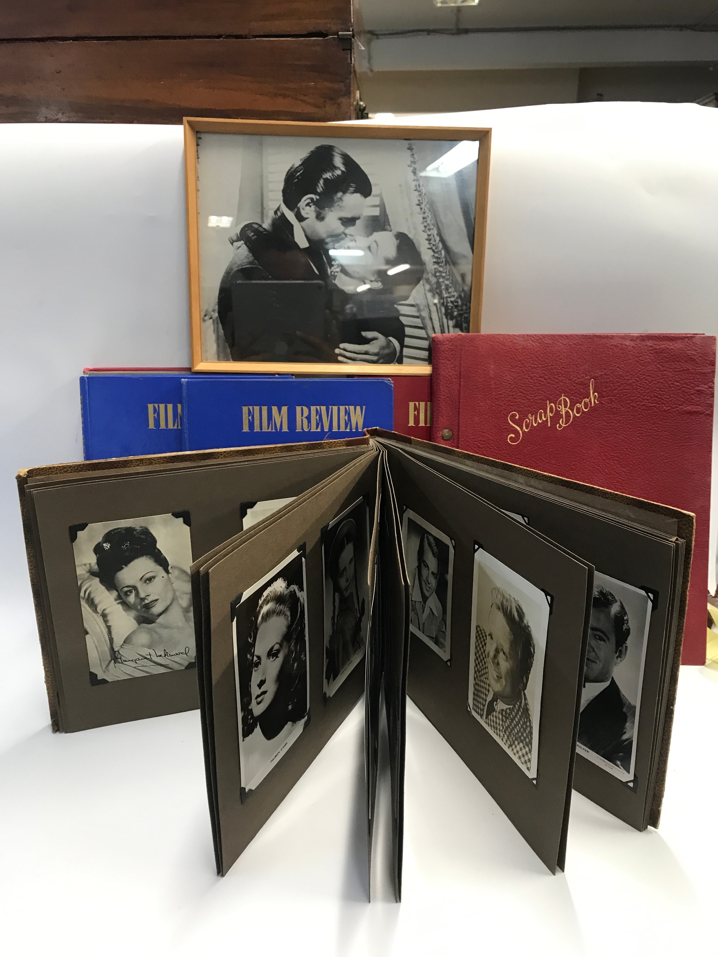 A collection of vintage hardback copies of Film Review and an album of film star photos with some authentic signatures. 