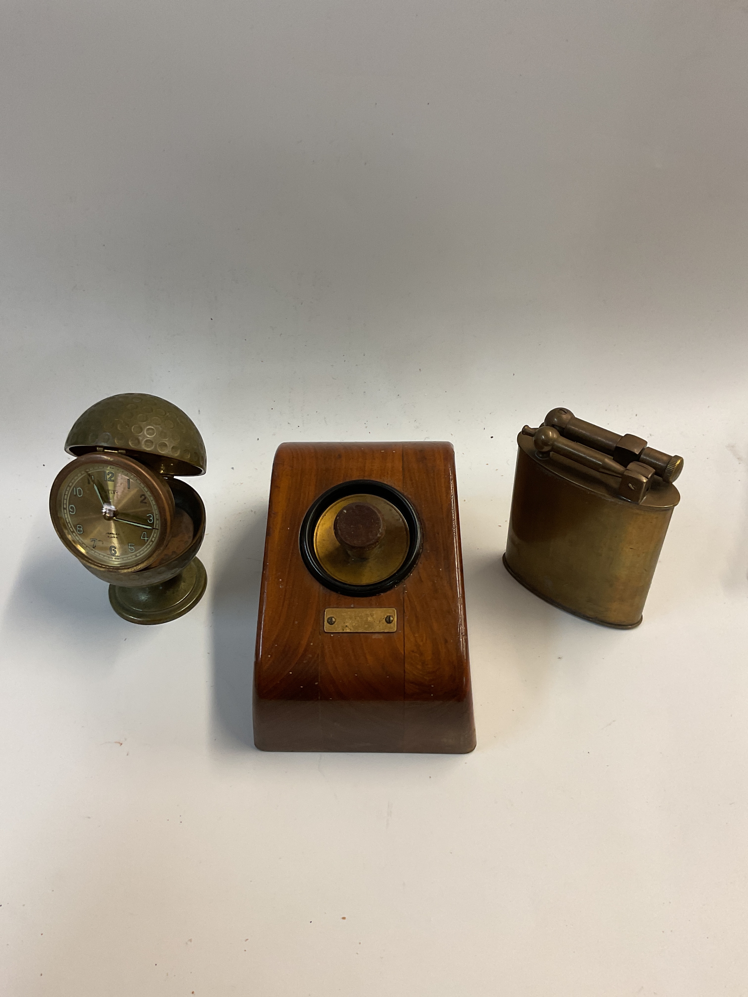 Electronic desk lighter, large brass lighter and golf ball clock.
