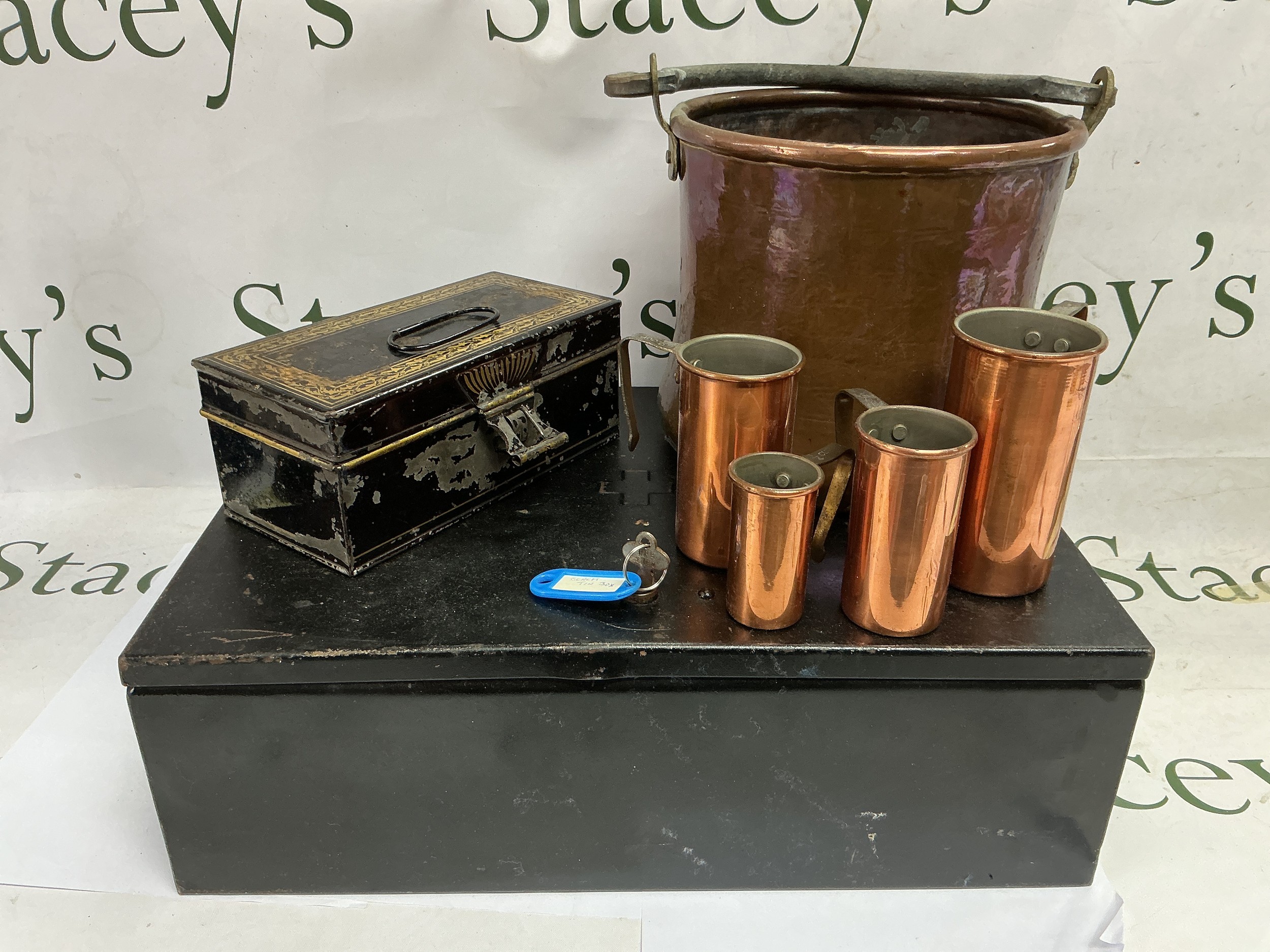 Two tins and a selection of copper pots.