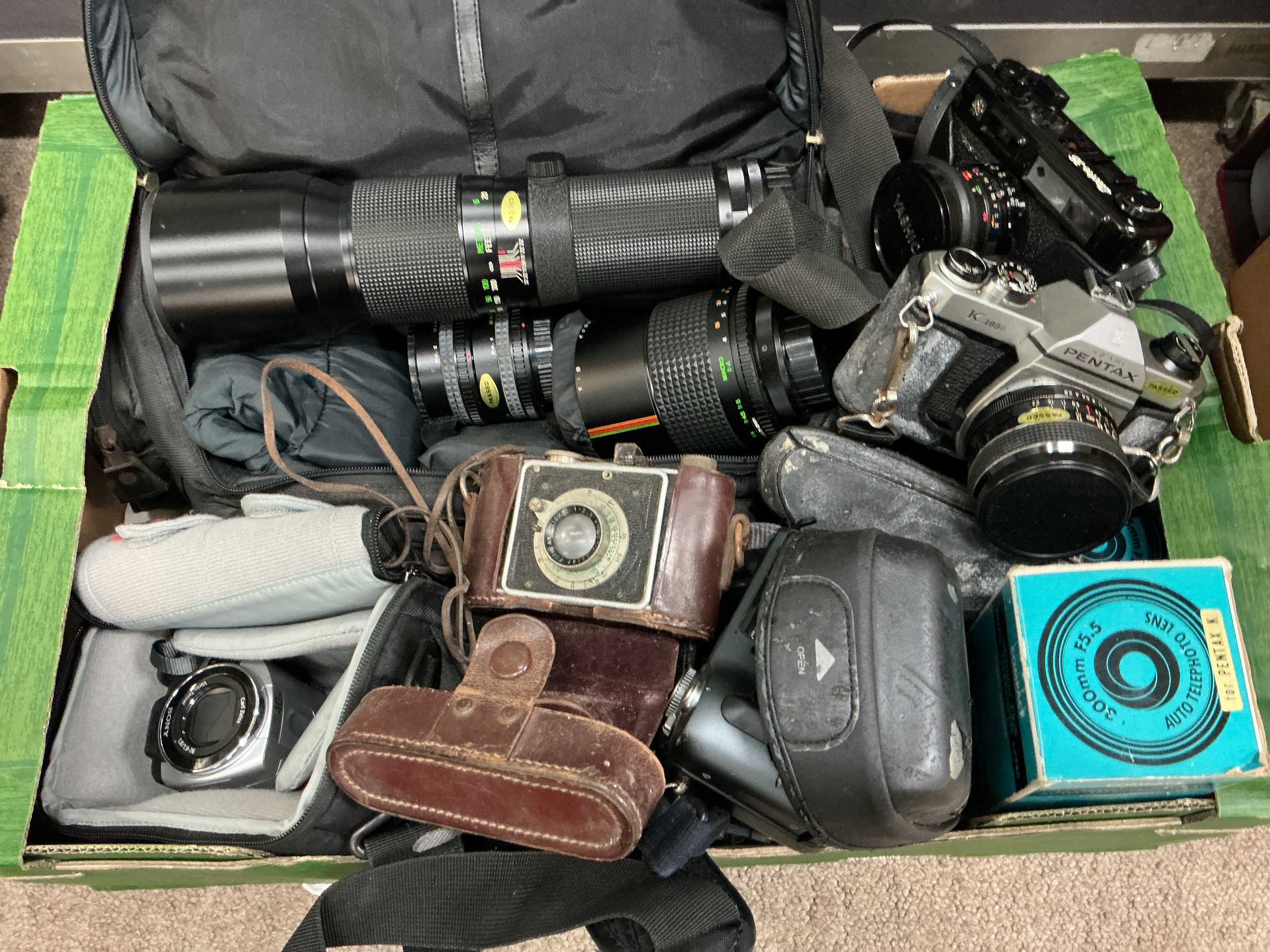 A collection of cameras, lenses and accessories.