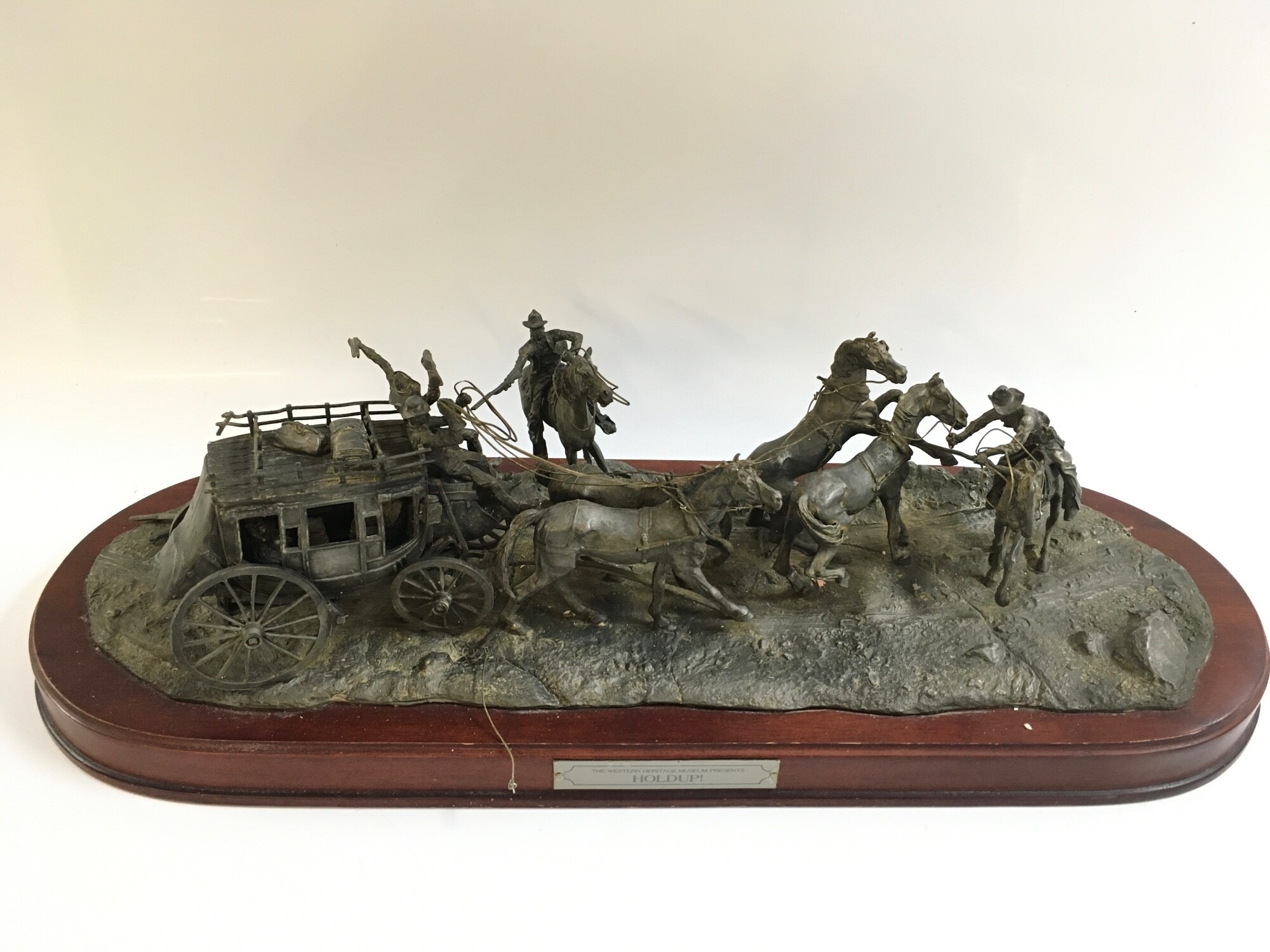 Franklin Mint Western Heritage Museum pewter sculpture titled the Holdup mounted on a wooden base. 6893/9500 .Stand 58cm wide