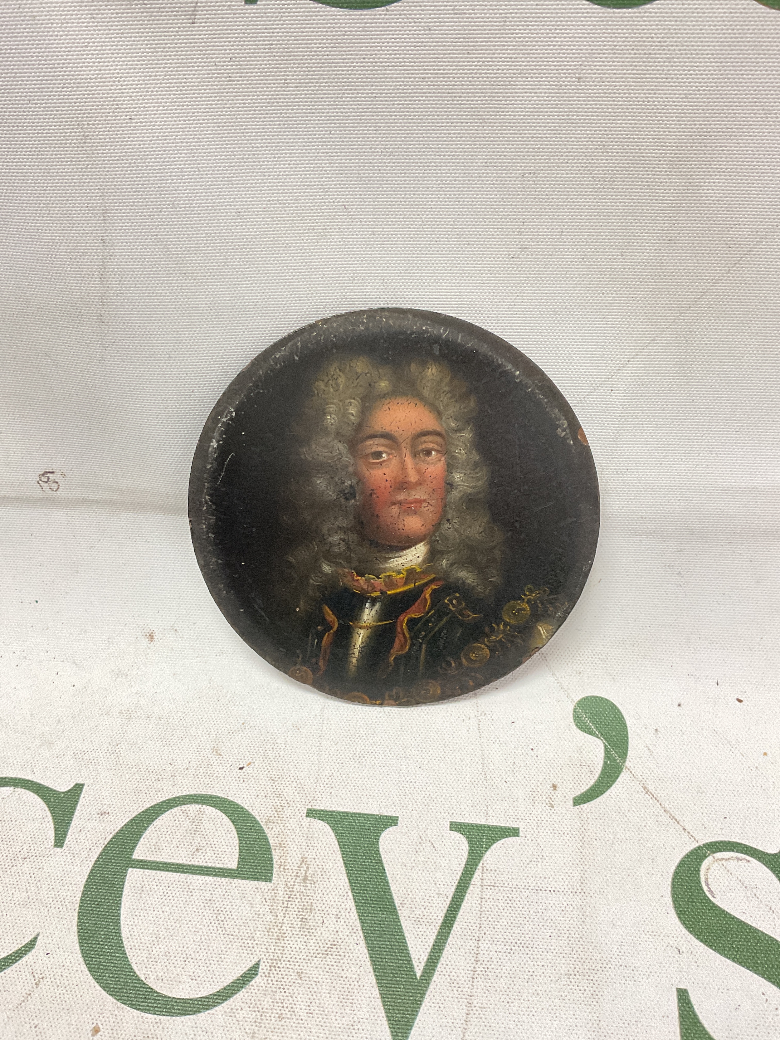 18/19th C portrait miniature of The Duke Of Marlborough in circular frame, oil on wood depicting the Duke with powdered wig and Cuirass with chain of office. Signed to the back in red paint, no artist signature. Miniature 7.5cm wide.