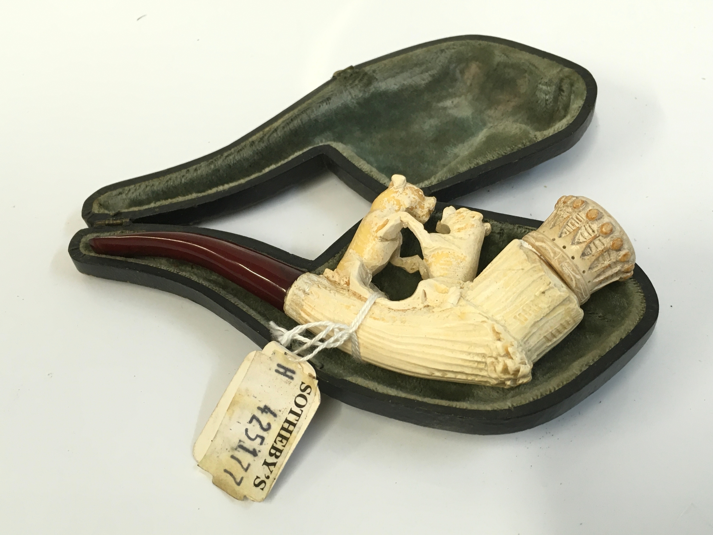 A cased Meerschaum tobacco pipe with a dog fight design, 13.5cm long