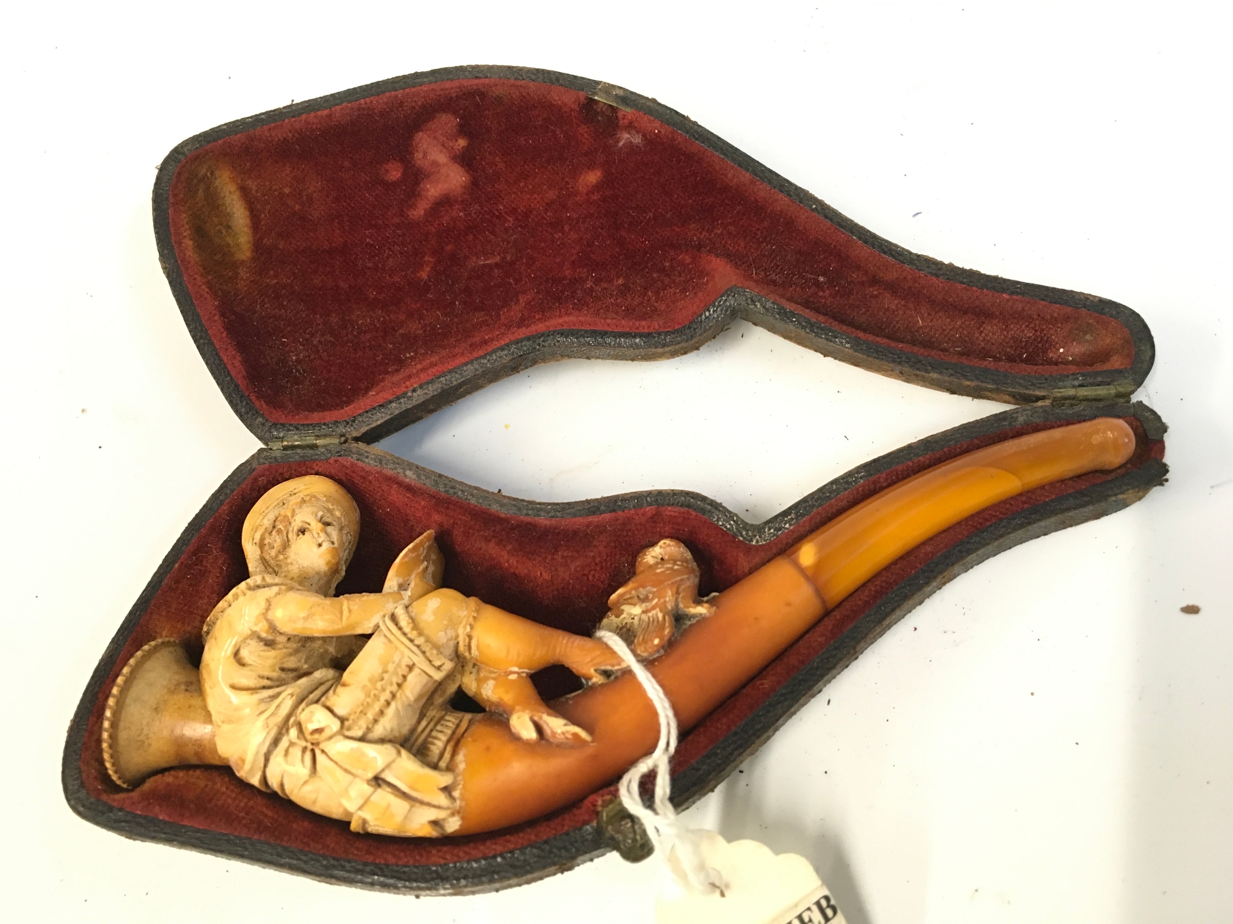 A Meerschaum tobacco pipe, lady seated with love birds design. 14cm long 