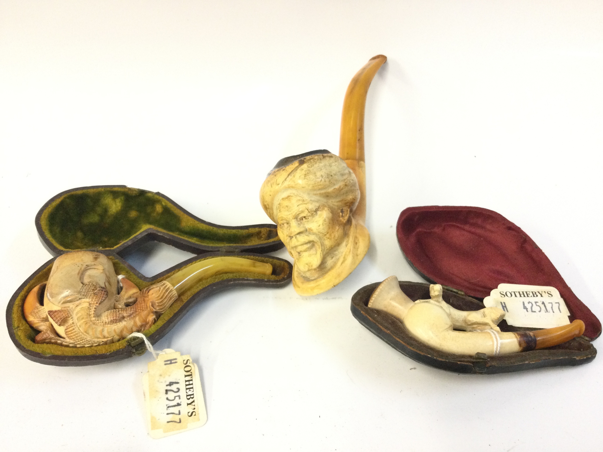 Three meerschaum tobacco pipes including a small claw pipe, turban man, horse (two cased) 9,11,17cm long 