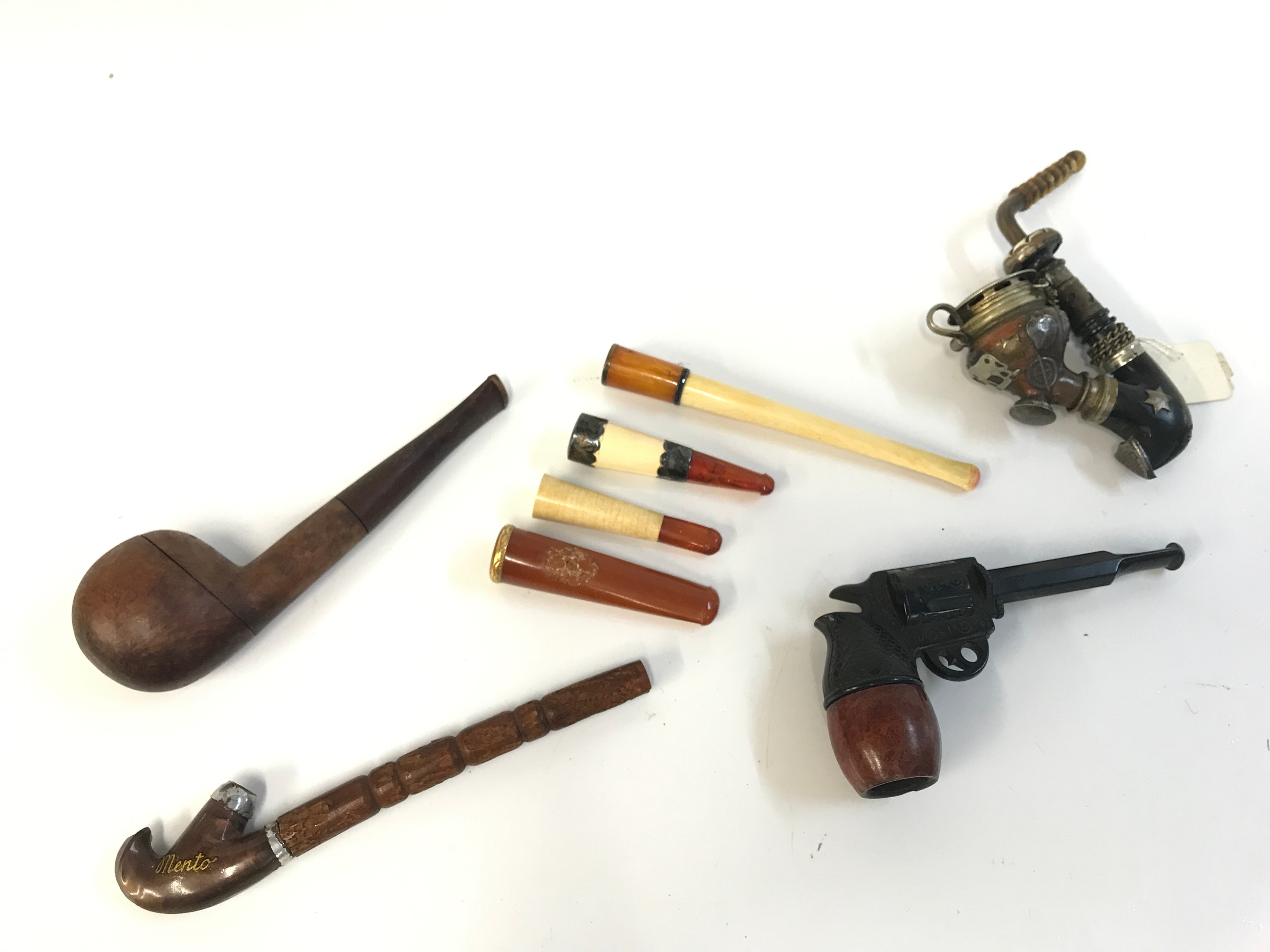 Smoking items including cheroot holders, gun design pipe and three others