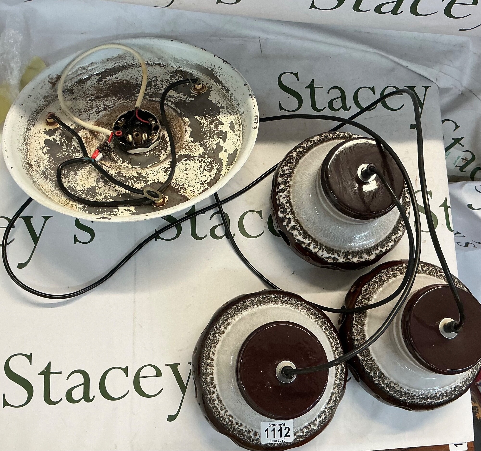Three identical ceramic German wall lights featuring a classic retro I tiered design finished with a multi toned reactive glaze. It combines a deep chocolate brown glossy top and bottom with a thick, frothy, textured cream band around the middle section. These are highly characteristic of European design from late 1960s to 70s. Additionally there is a ceiling canopy which houses the central junction and electrical terminal block meant to be wired directly in to houses ceiling supply. NO RESERVE