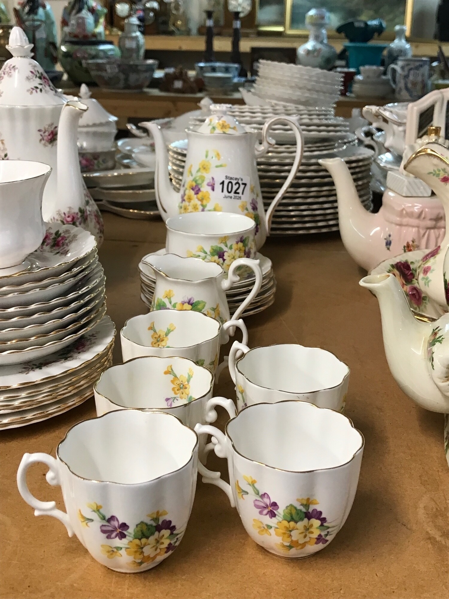 A Royal Doulton bone chine coffee set decorated with flowers, including coffee pot, sugar bowl, cups, cream jug and saucers