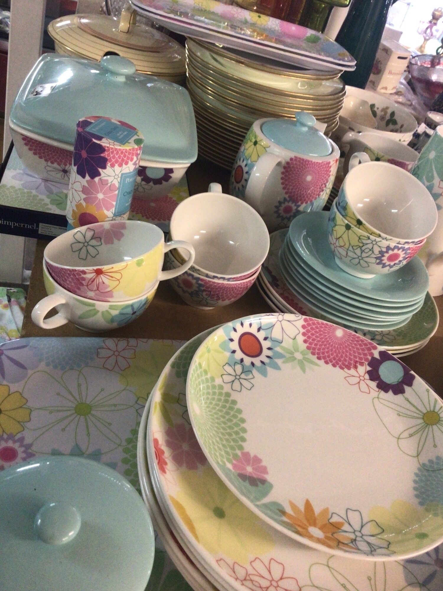 A Portmeirion 20th century dinner service The Crazy Daisy pattern comprising plates of mixed sizes tureen. Coffee pot cups saucers and more also matching serving trays place matts table runners. All no obvious damage.