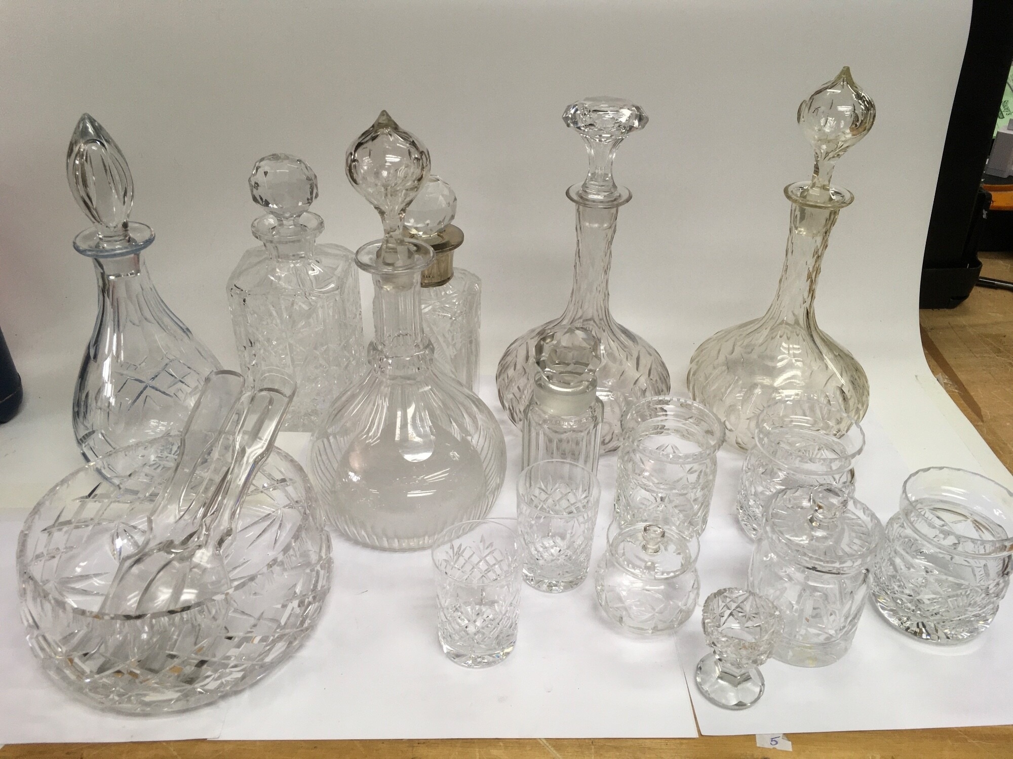 A collection of cut glass items comparing a silver collared decanter, bowl, glasses, decanters etc. NO RESERVE