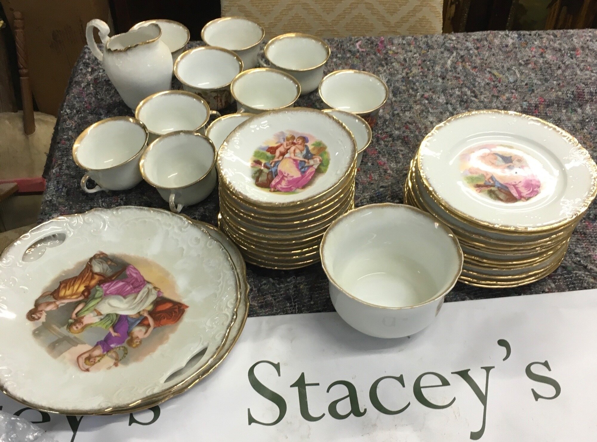 Highly decorative, antique ceramic tea set featuring romantic classical imagery
