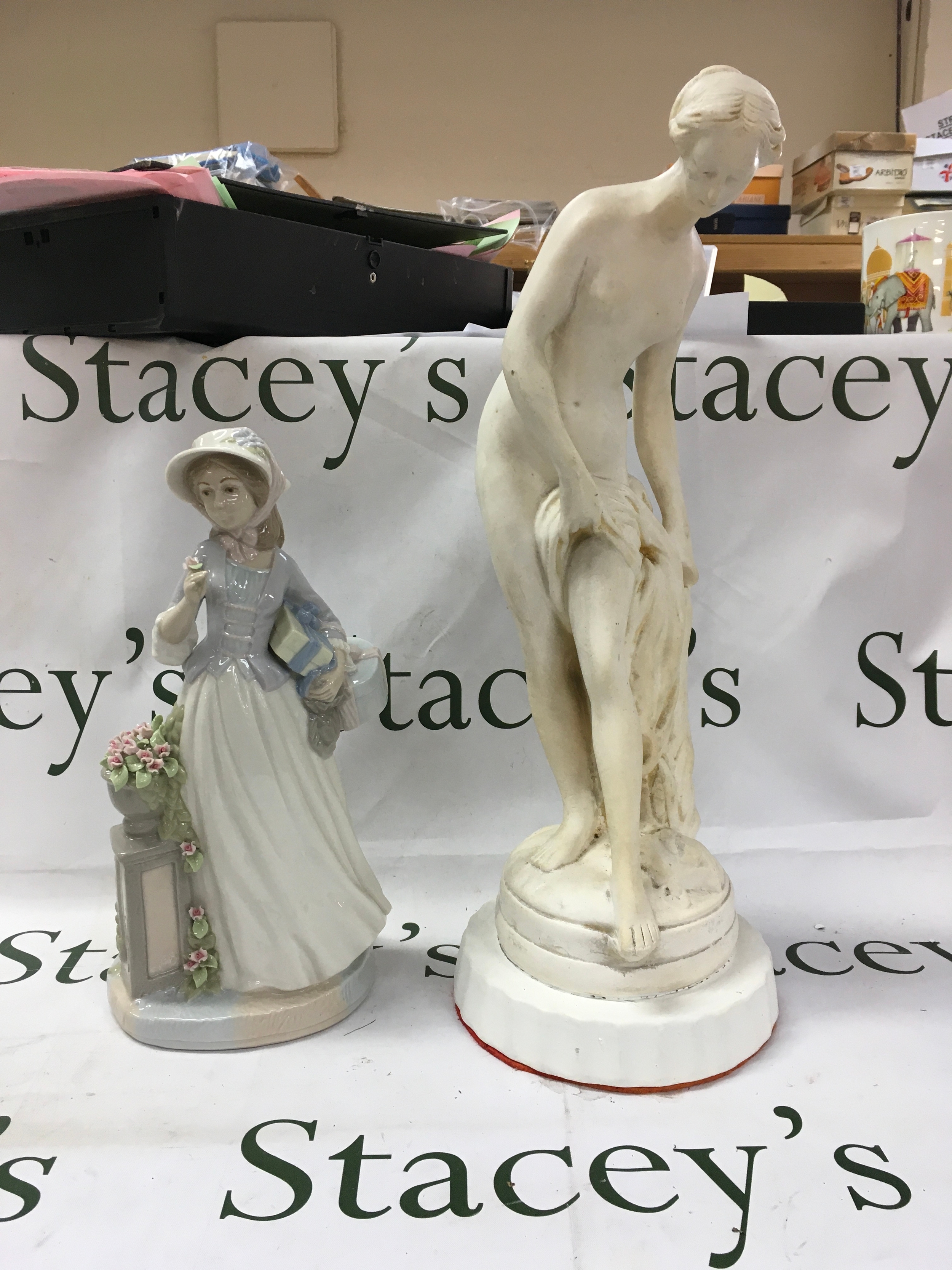 The item on the left is a Spanish porcelain figurine produced by Nadal, 32cm. The item on the right is a sculpture replica of La Baigneuse, 48cm. 