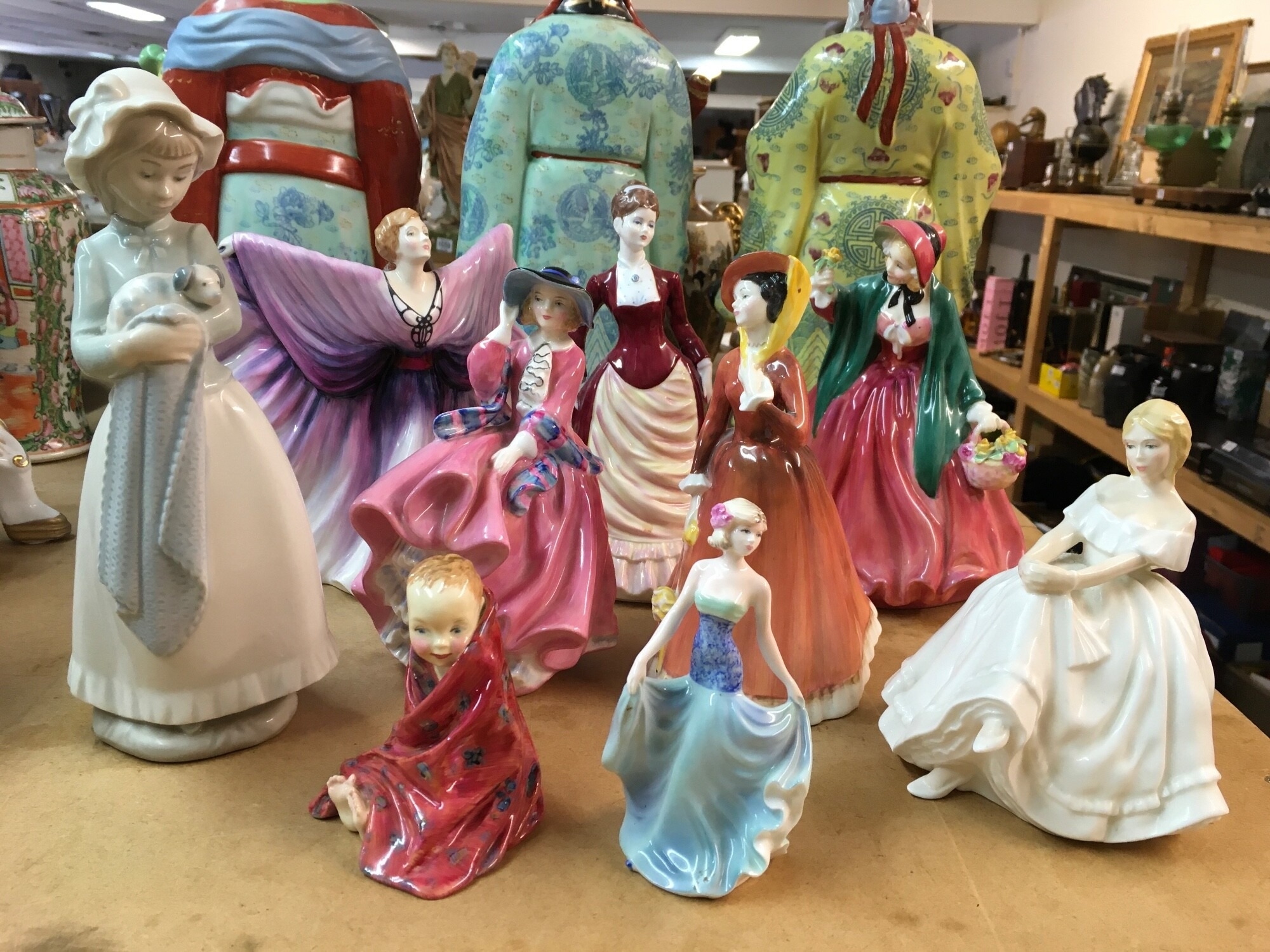 A collection Royal Doulton figurines, including This Little Pig HN 1793, a Coalport figure and a Nao