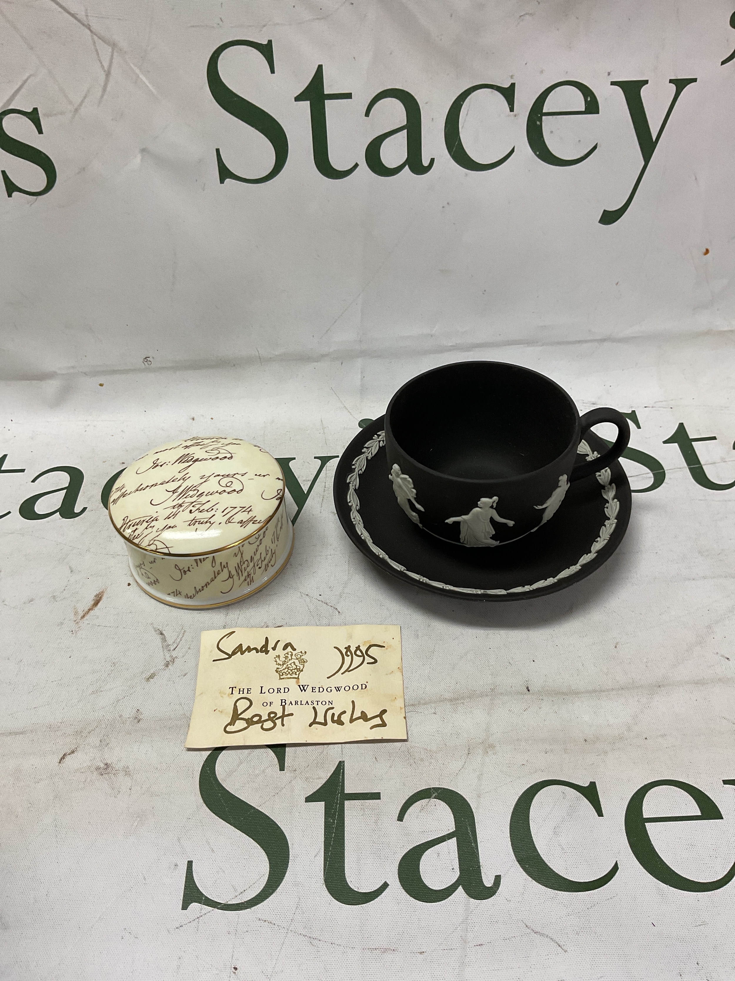 Wedgwood black jasper ware cup and saucer and a signed bicentenary lidded pot along with signed card of The Lord Wedgwood 1995.