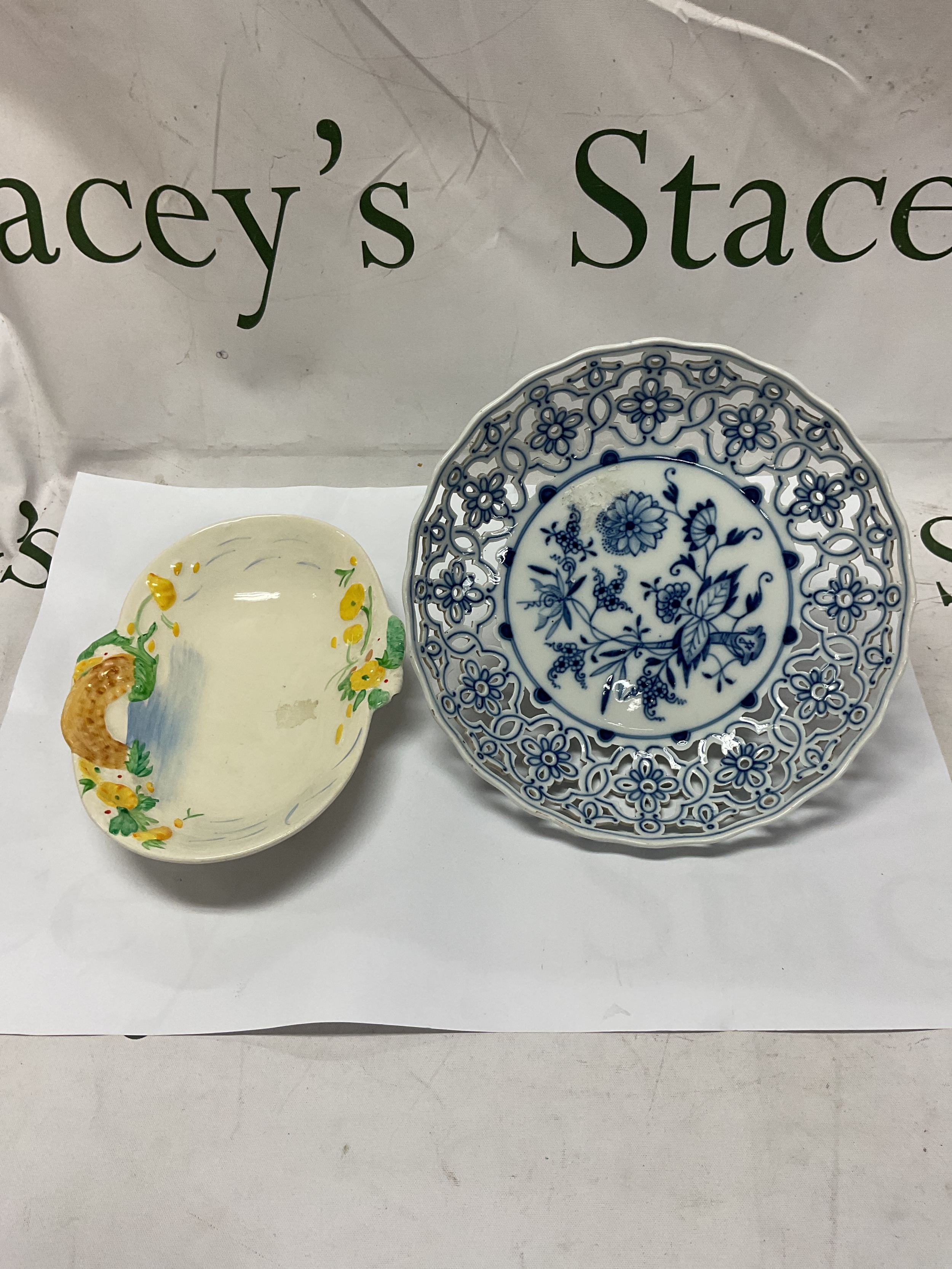 Meissen Crossed sword signed pierced blue and white three dolphin legged dish, along with a Clarice Cliff Newport Bridge over stream pattern dish.
