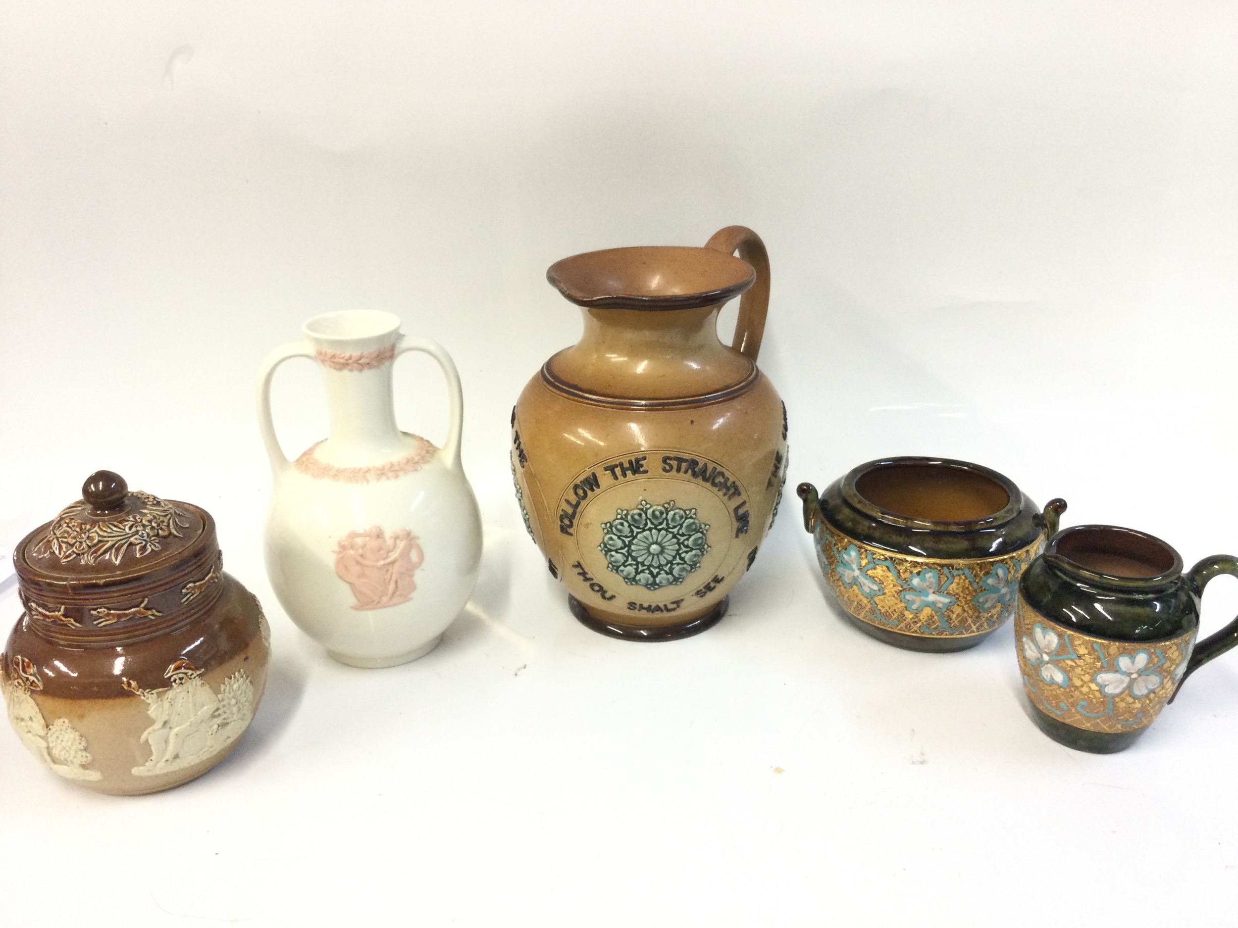 Royal Doulton slater patent stonewear items, 19th-century Doulton Lambeth stoneware motto jug, Wedgwood Queensware trophy vase and a Doulton Lambeth stoneware jug. 8 to 18cm tall