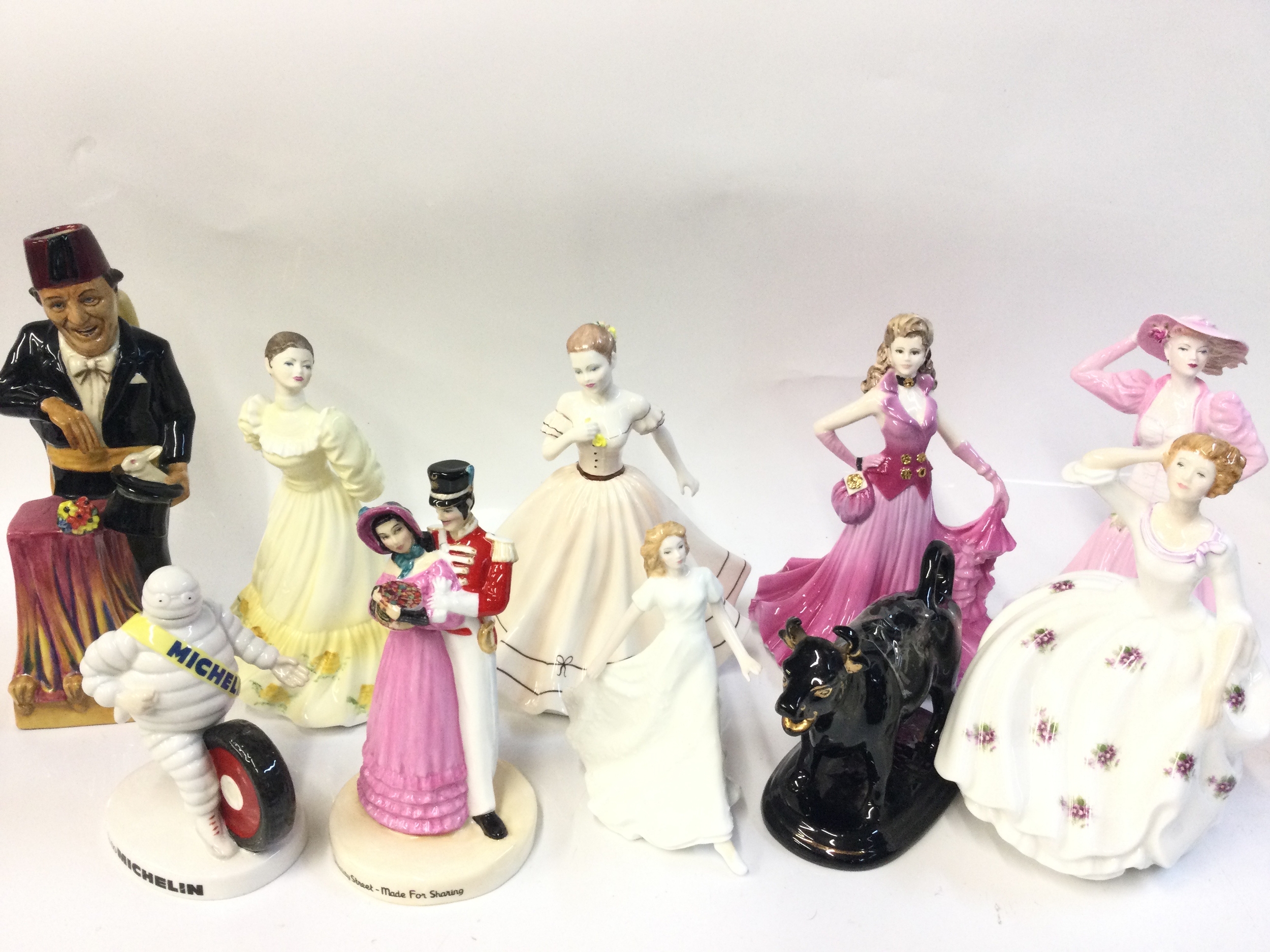 A collection of porcelain figures including Royal Doulton Michelin man, Quality street couple, Maureen , Kevin Francis Tommy Cooper figure signed by R.M David/Andy Moss etc 