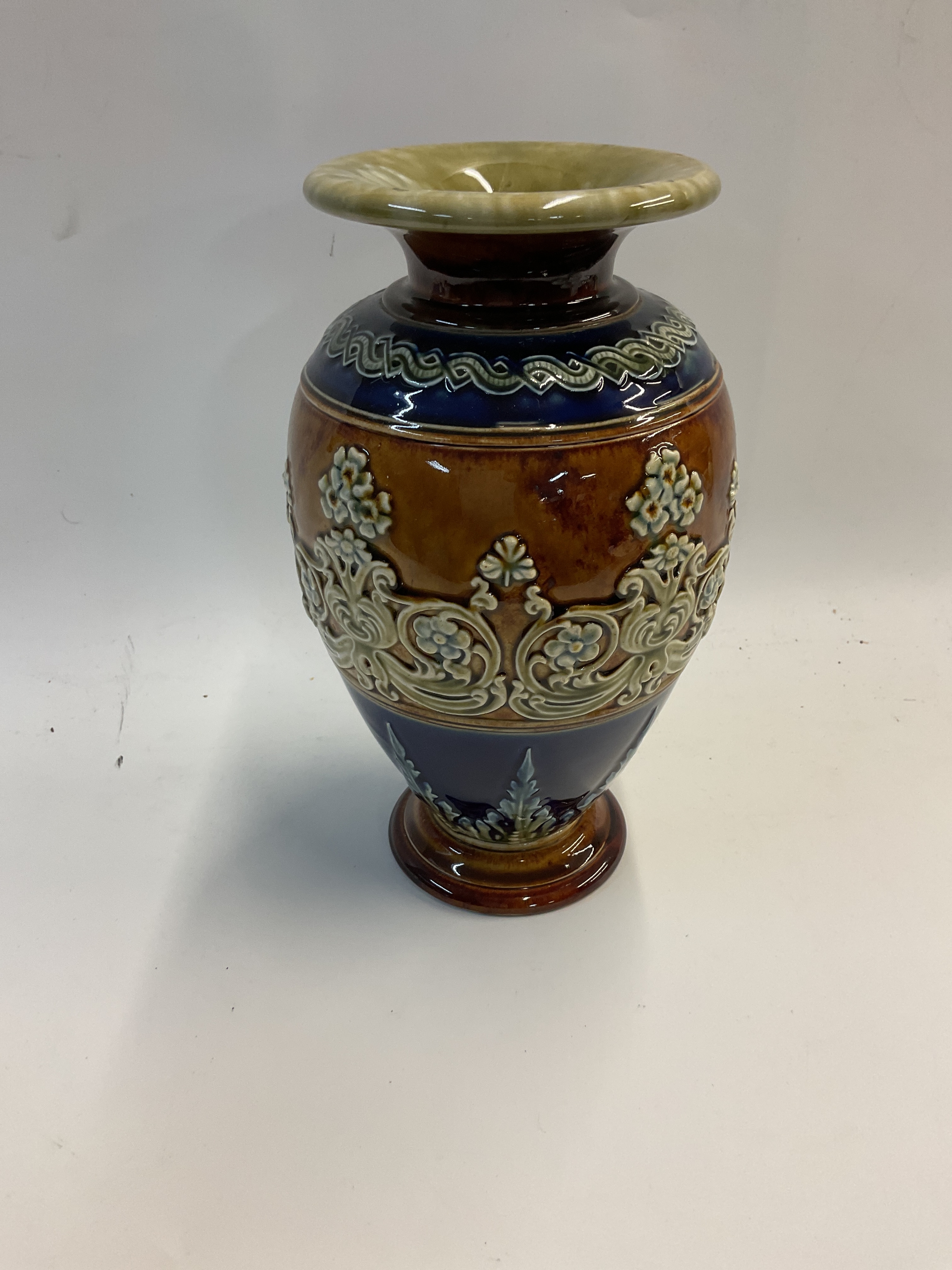 Royal Doulton Lambeth vase in blues and brown, marked to base and initialled MH.height 23cm.