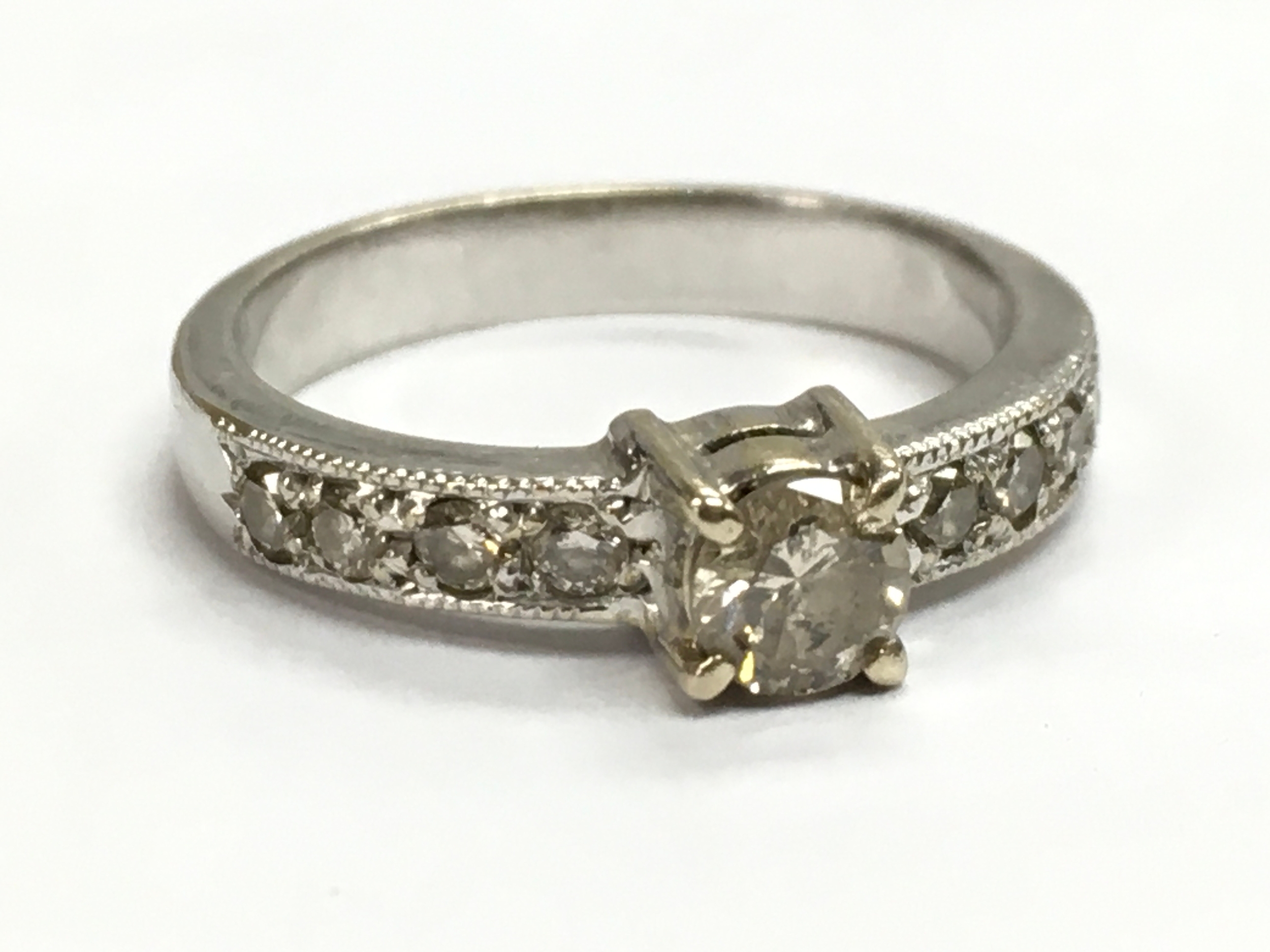 An unmarked 14ct white gold brilliant-cut diamond solitaire ring (0.25 carat main stone), size L/M. 3.4g