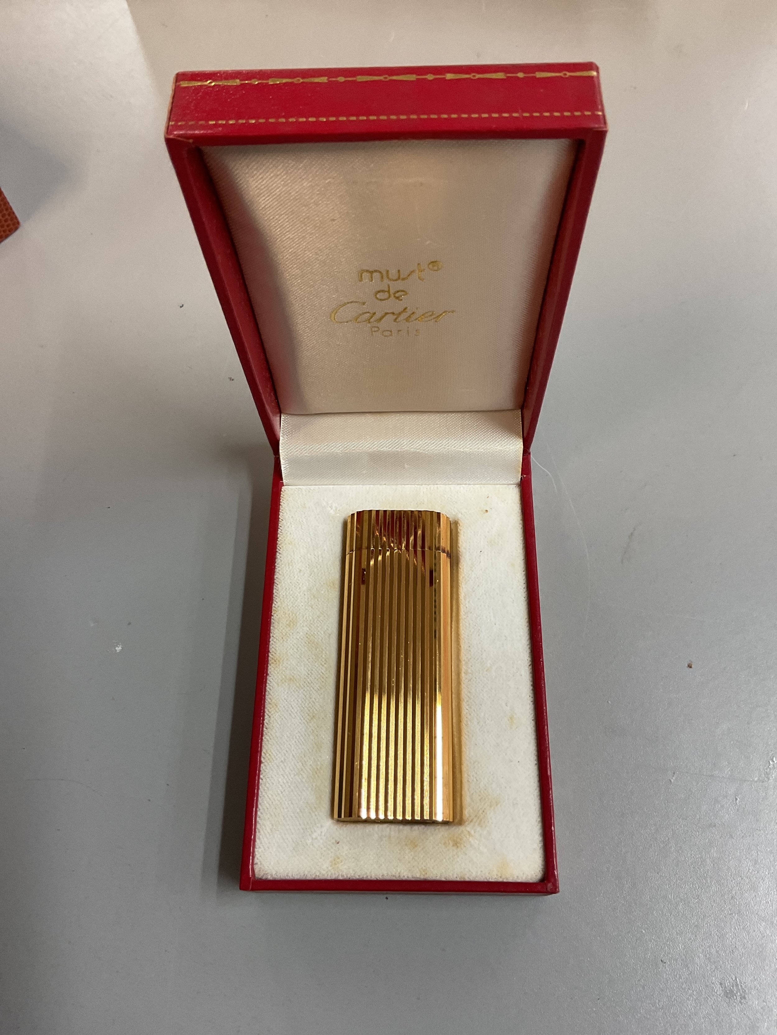 Cased Must de Cartier lighter.