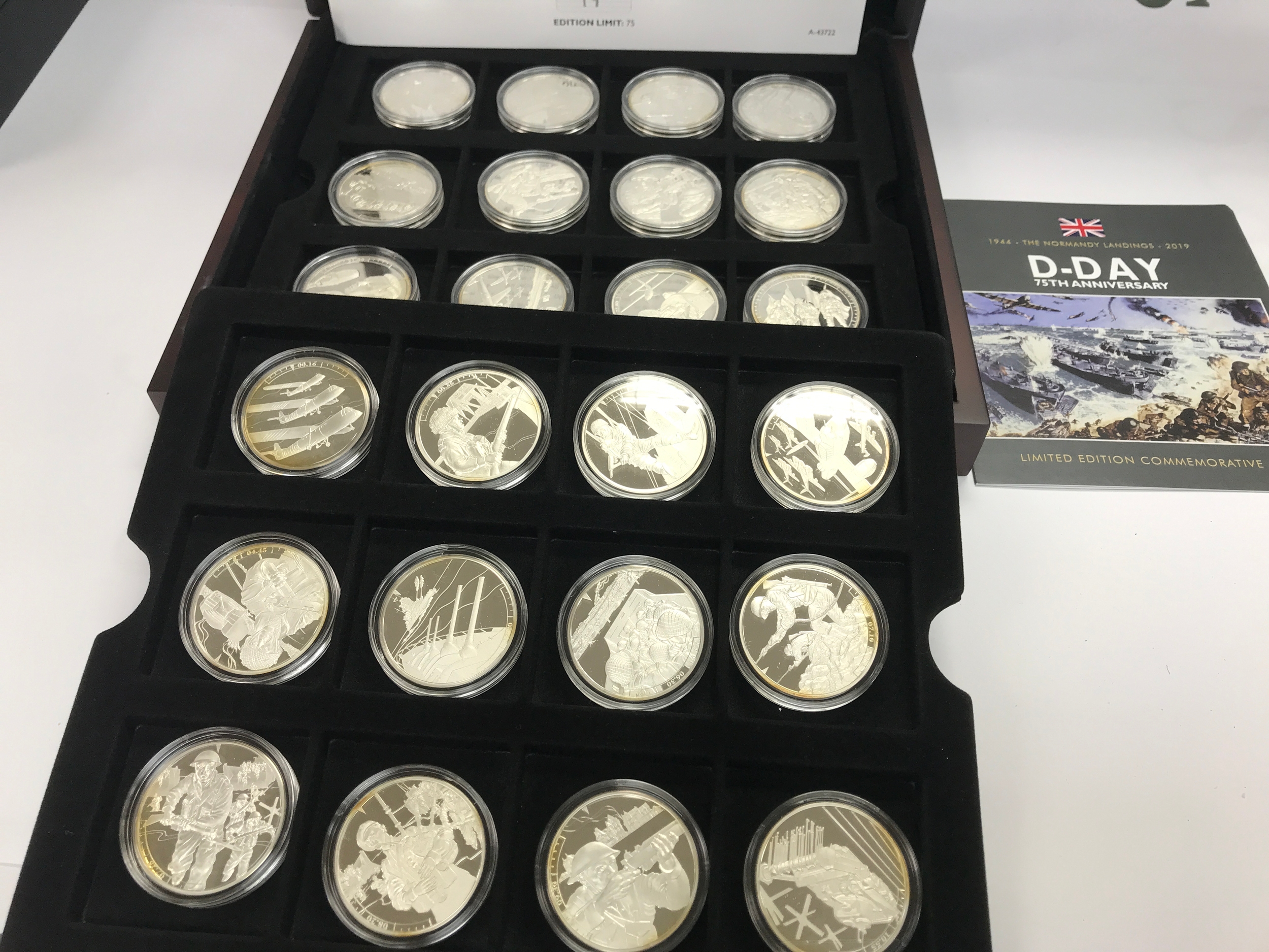 limited edition 2019 D-Day 75th Anniversary commemorative coin set issued for Guernsey and Jersey, featuring 24 sterling silver £5 coins.