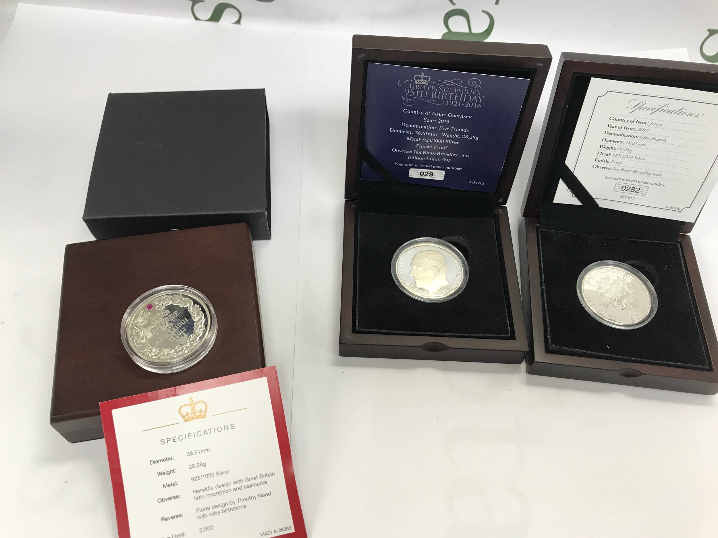 Three silver commemorative coins.